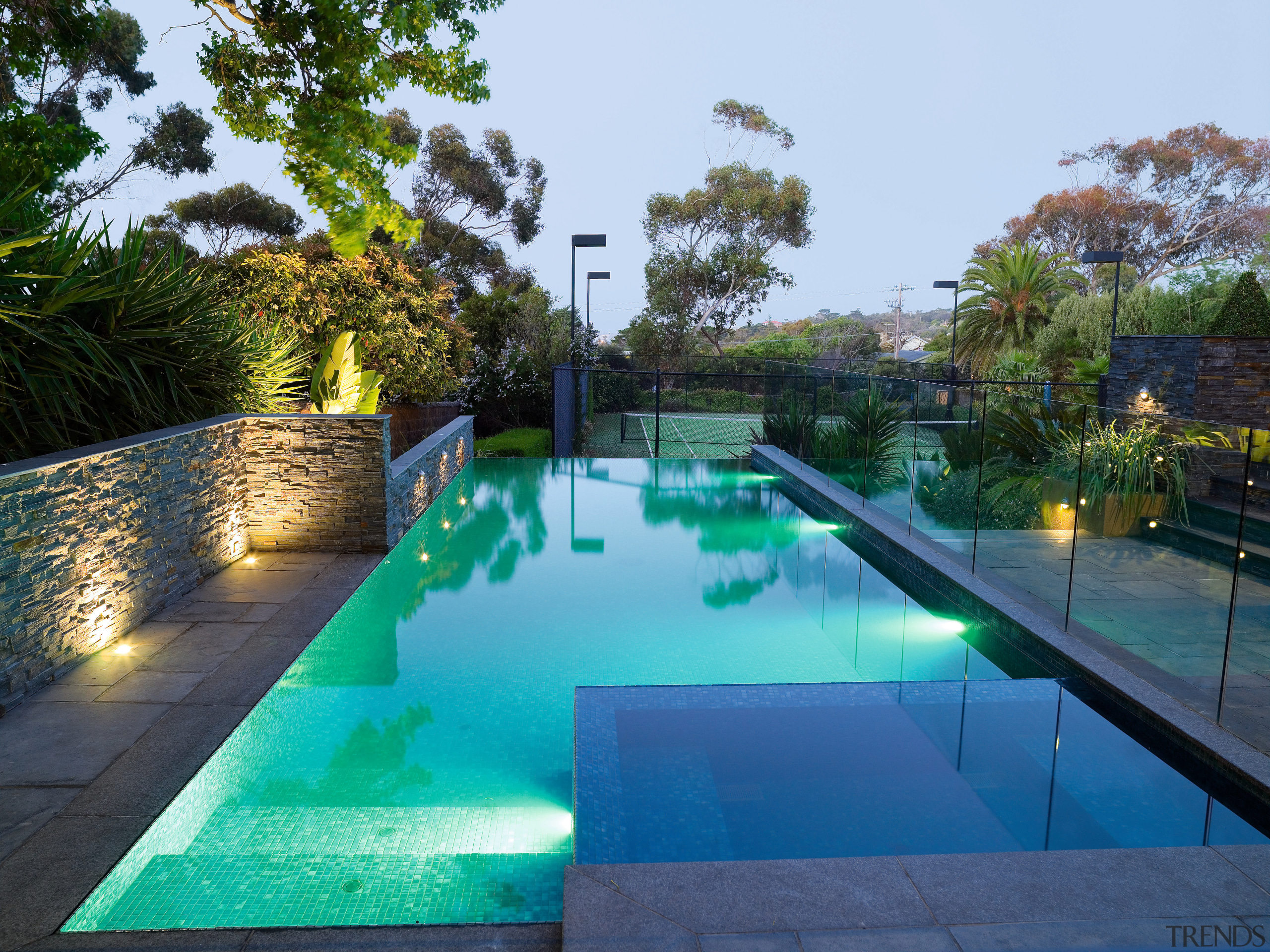 A view of the pool feauting an infinty backyard, estate, leisure, plant, property, real estate, reflecting pool, reflection, resort, swimming pool, tree, water, teal