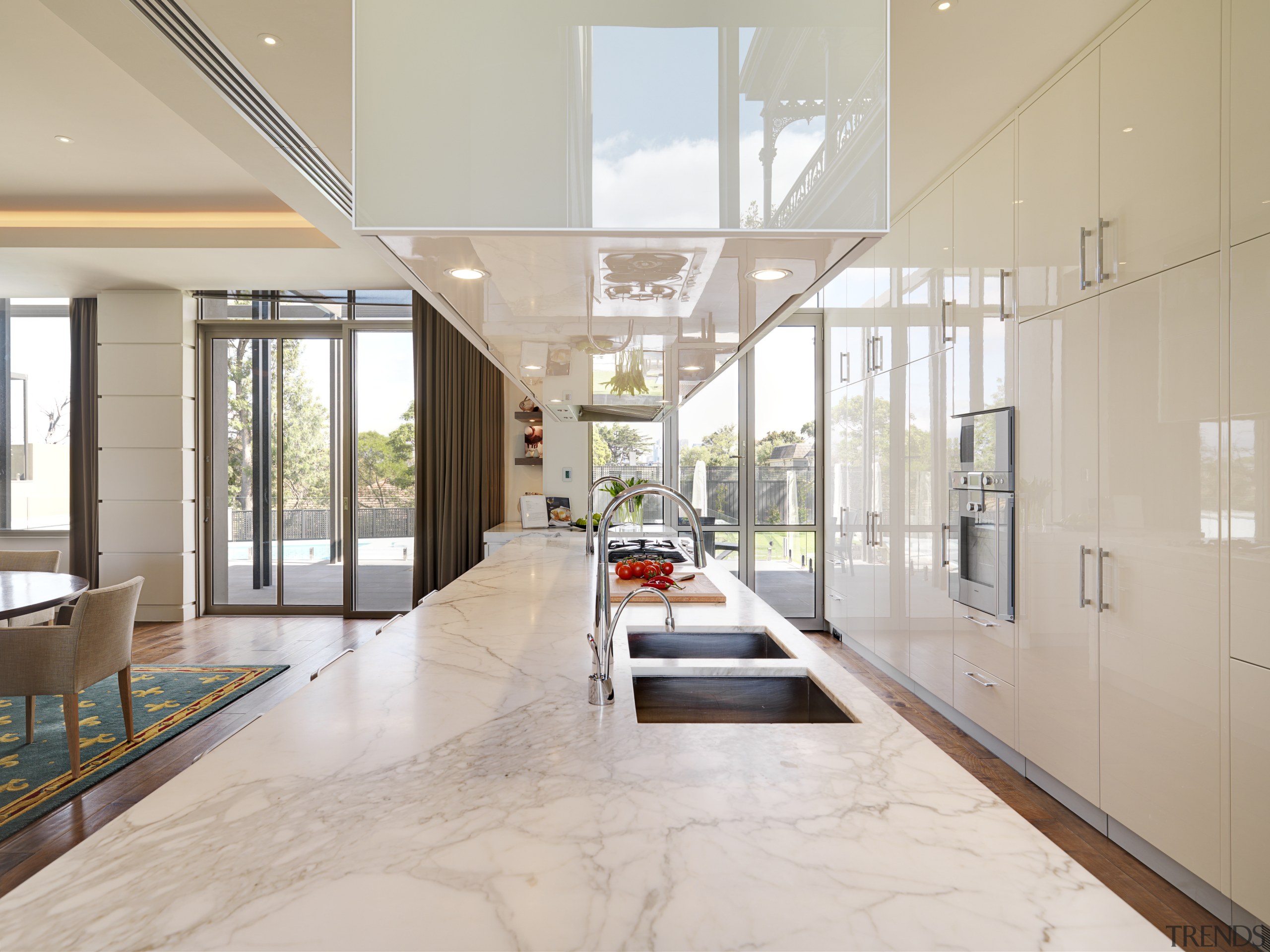 View of large marble island with cooktop, sinks apartment, architecture, ceiling, daylighting, estate, floor, flooring, house, interior design, living room, lobby, real estate, gray