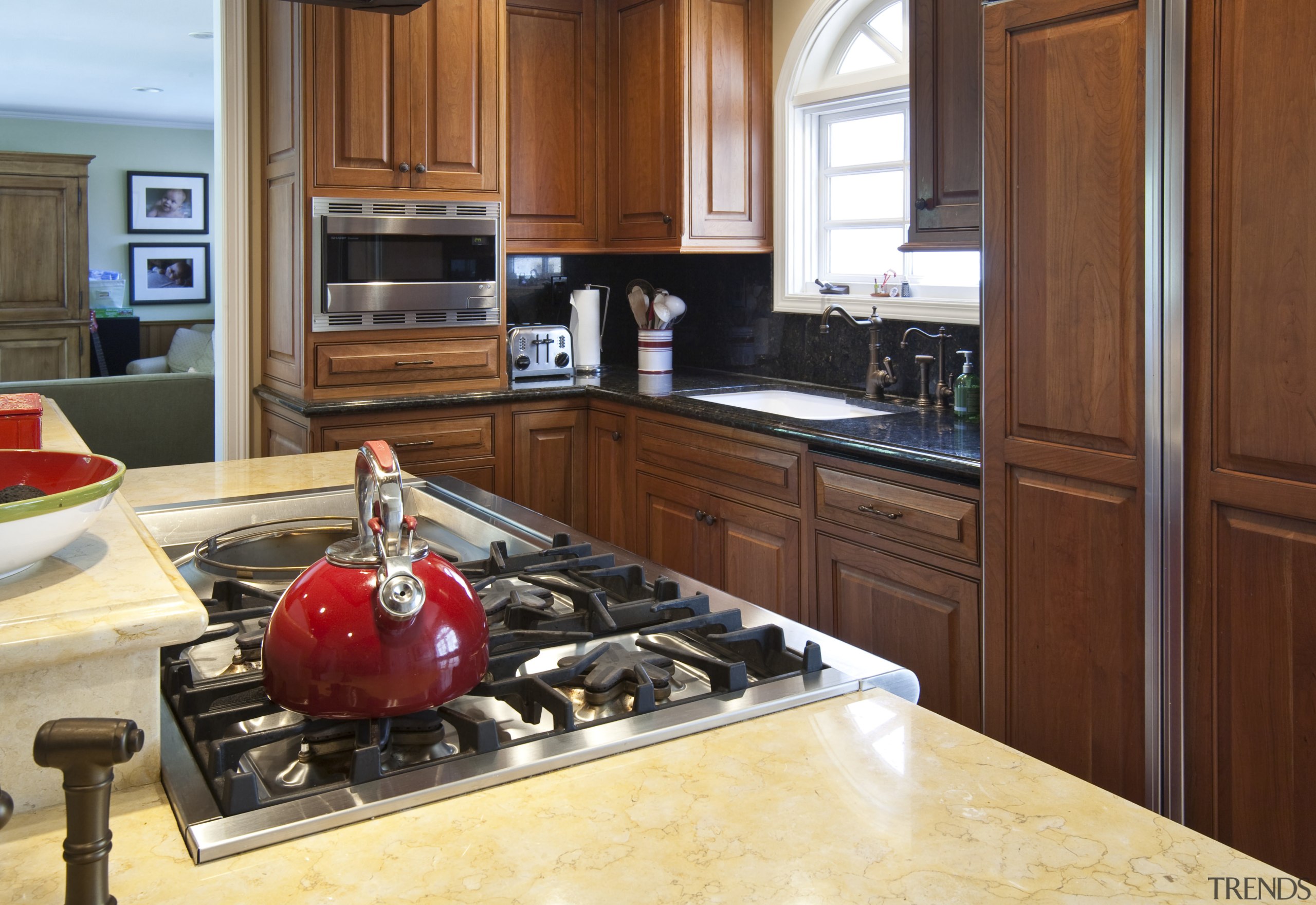 View of a traditional-styled kitchen designed by Pacific cabinetry, countertop, cuisine classique, hardwood, interior design, kitchen, room, brown