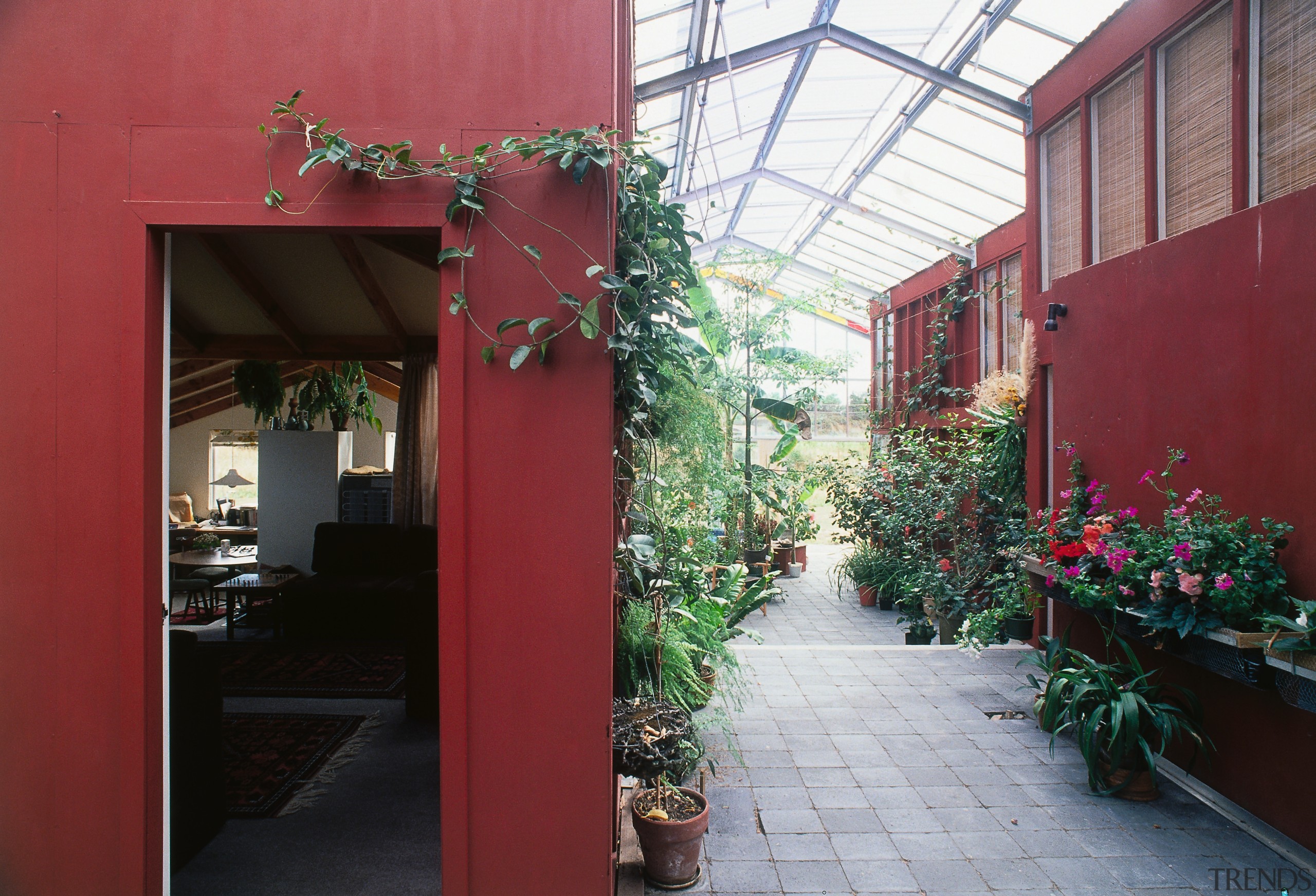 An interior view of the glasshouse where the architecture, courtyard, facade, floristry, flower, home, house, outdoor structure, plant, real estate, window, red