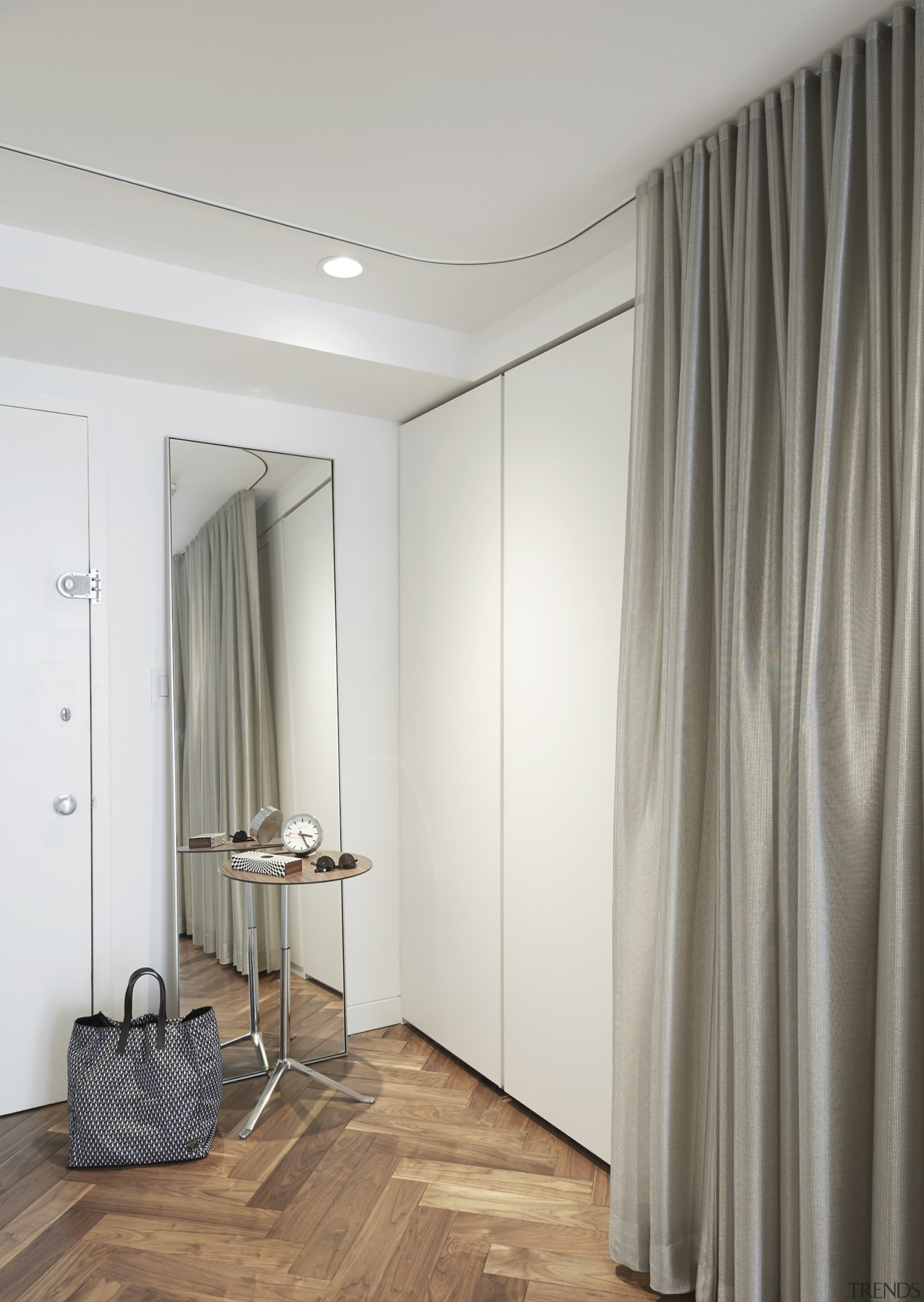 Storage cupboards sit next to the front door. ceiling, curtain, door, floor, flooring, furniture, interior design, room, textile, wall, wardrobe, window, window covering, window treatment, gray