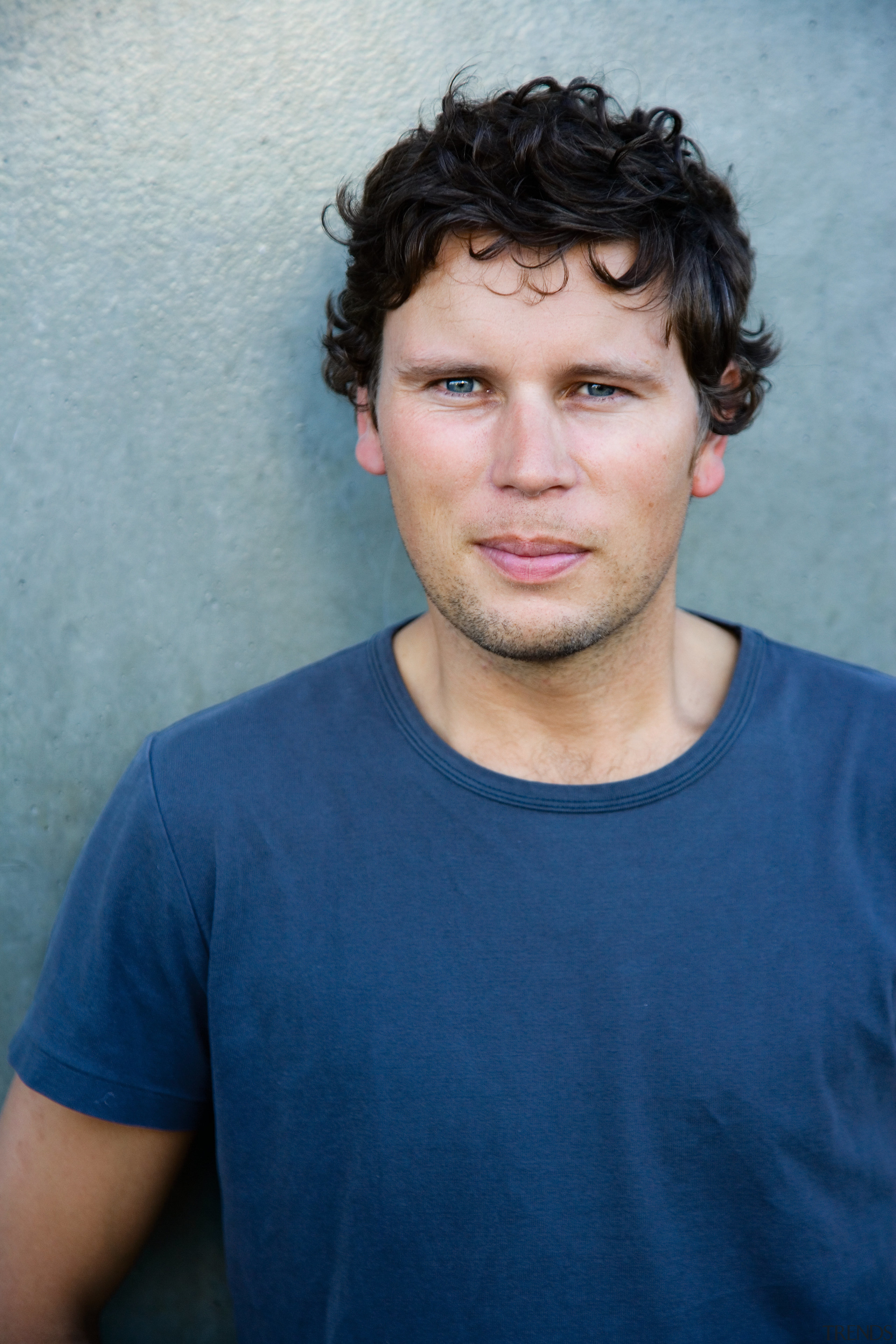 Portrait phote of simon james afurniture designer - black hair, blue, cheek, chin, cool, eye, face, forehead, hairstyle, man, person, portrait, smile, blue, gray