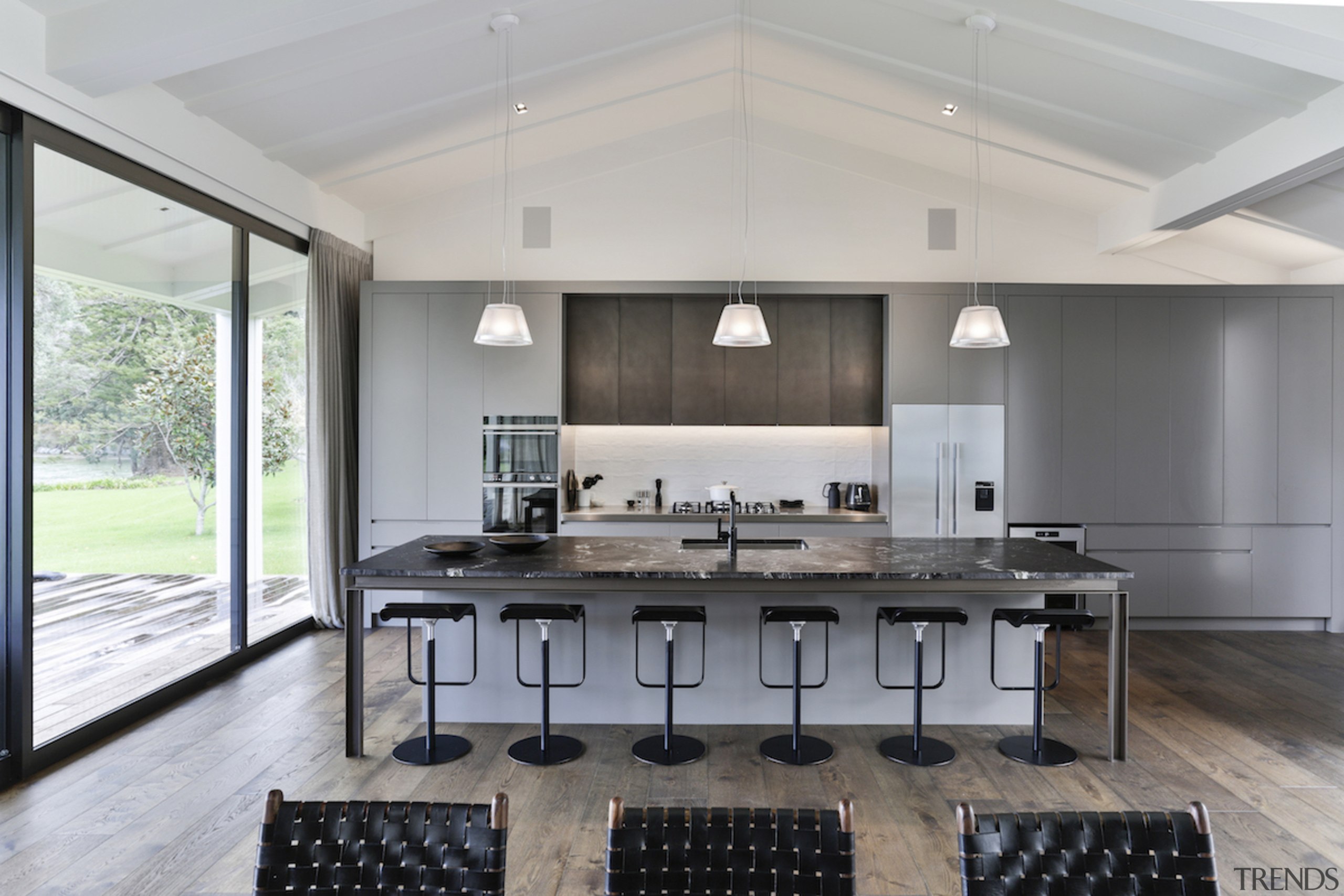 Anchoring the central cooking bench are larger elements ceiling, countertop, daylighting, floor, flooring, house, interior design, kitchen, real estate, table, gray