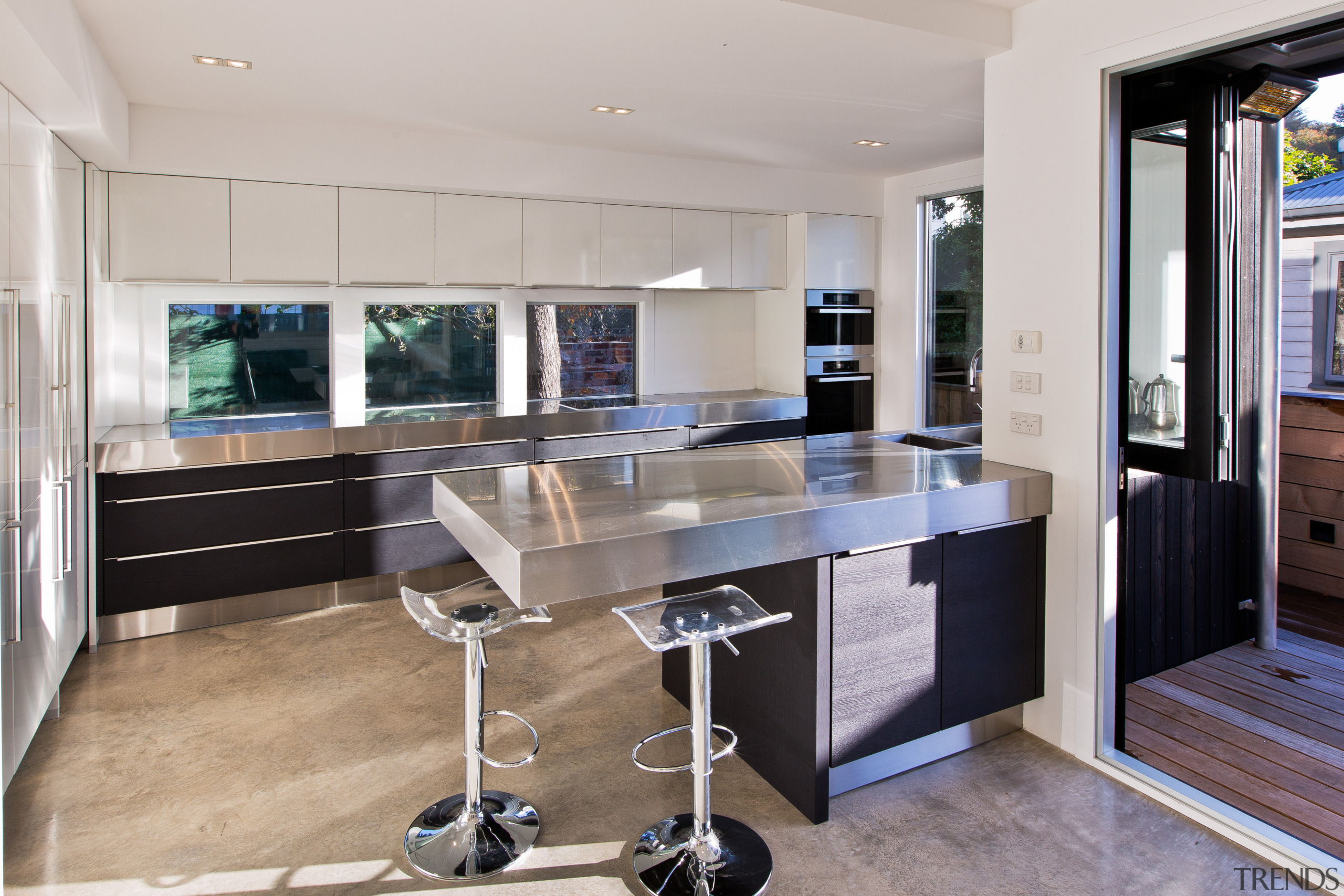 This kitchen by designer Milvia Hannah responds to countertop, floor, interior design, kitchen, real estate, gray