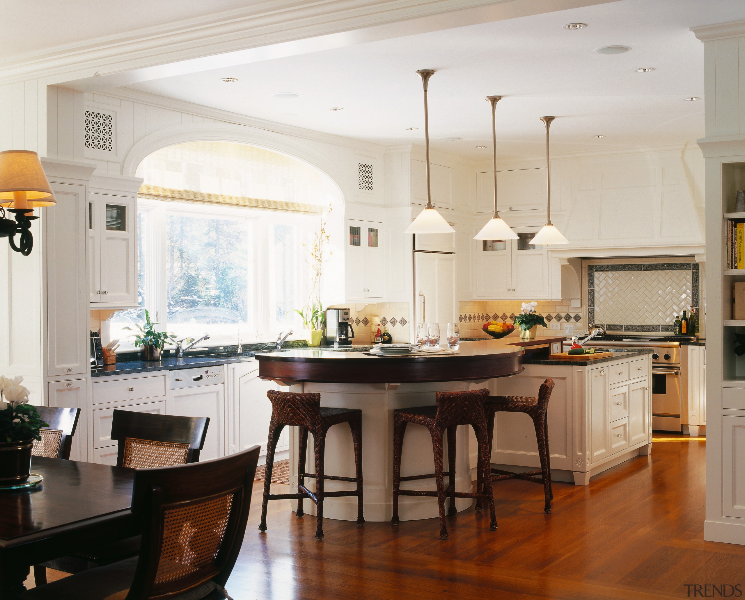 view of the kitchen  featuring large windows, cabinetry, ceiling, countertop, cuisine classique, dining room, floor, flooring, hardwood, home, interior design, kitchen, room, window, wood flooring, white