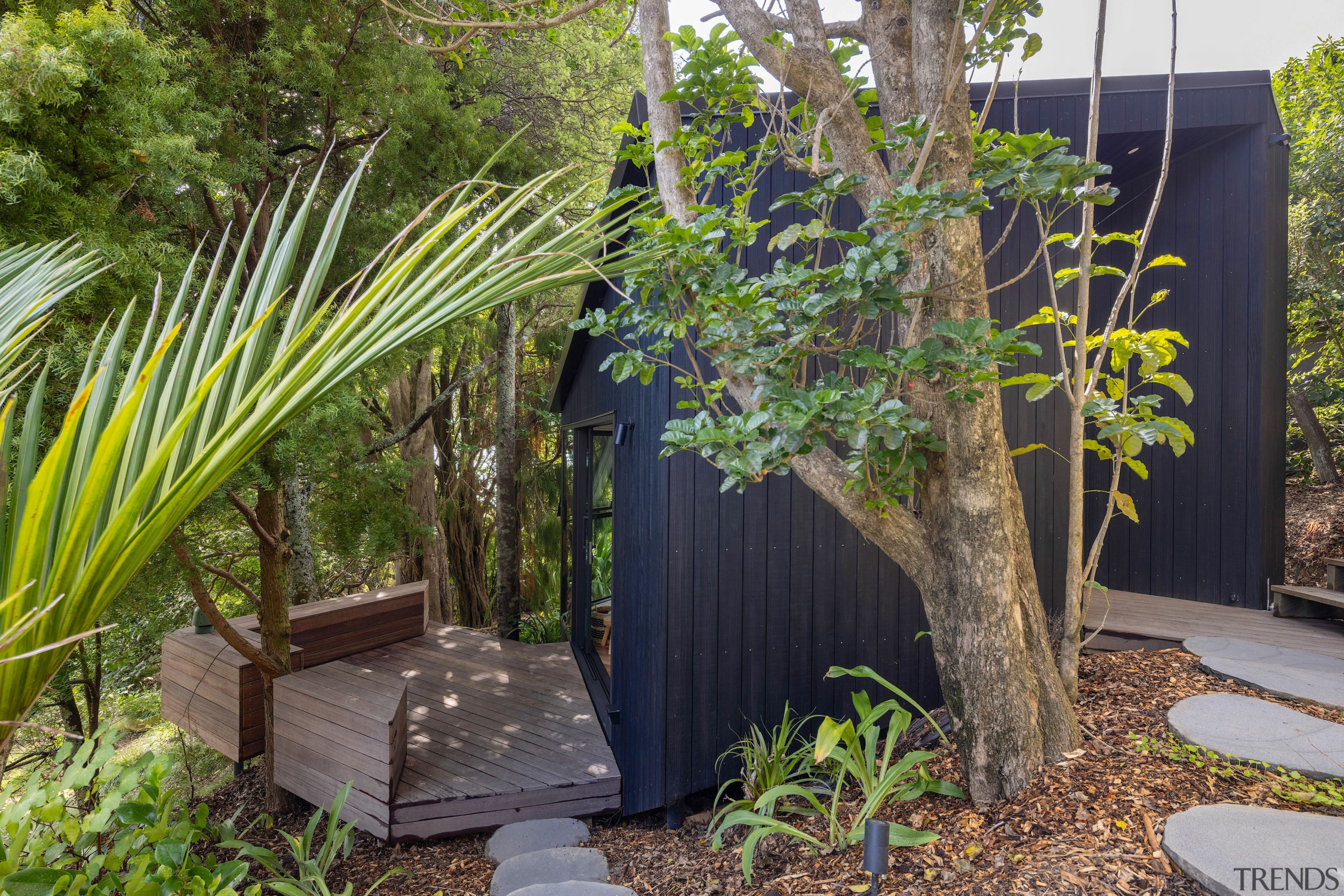 Dark stained Adobo Vulcan vertical weatherboard cladding visually 