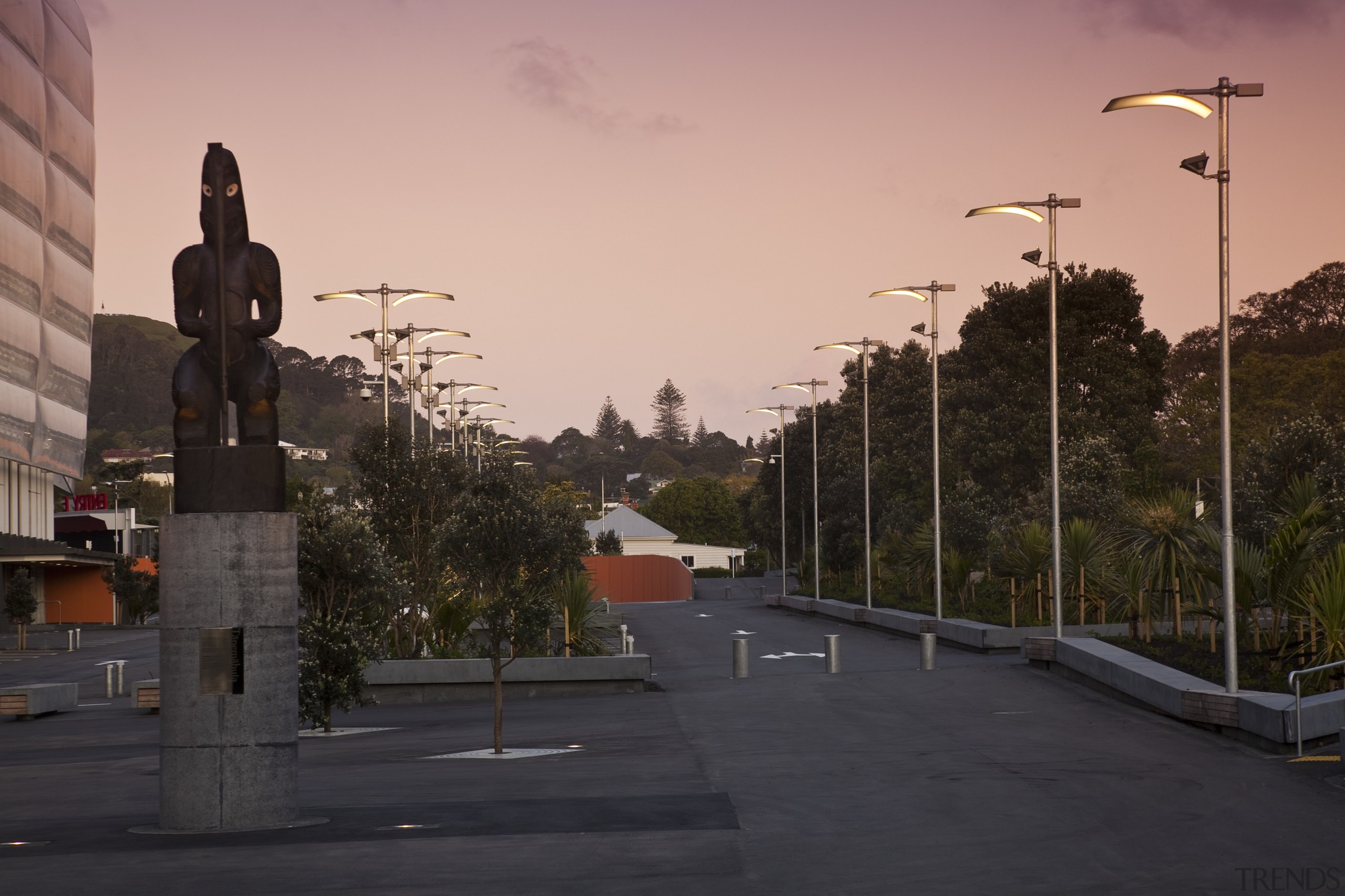 Singer Group undertook the broad array of electrical city, evening, infrastructure, lane, morning, neighbourhood, residential area, road, sky, street, street light, sunlight, town, tree, urban area, walkway, wall, black, orange