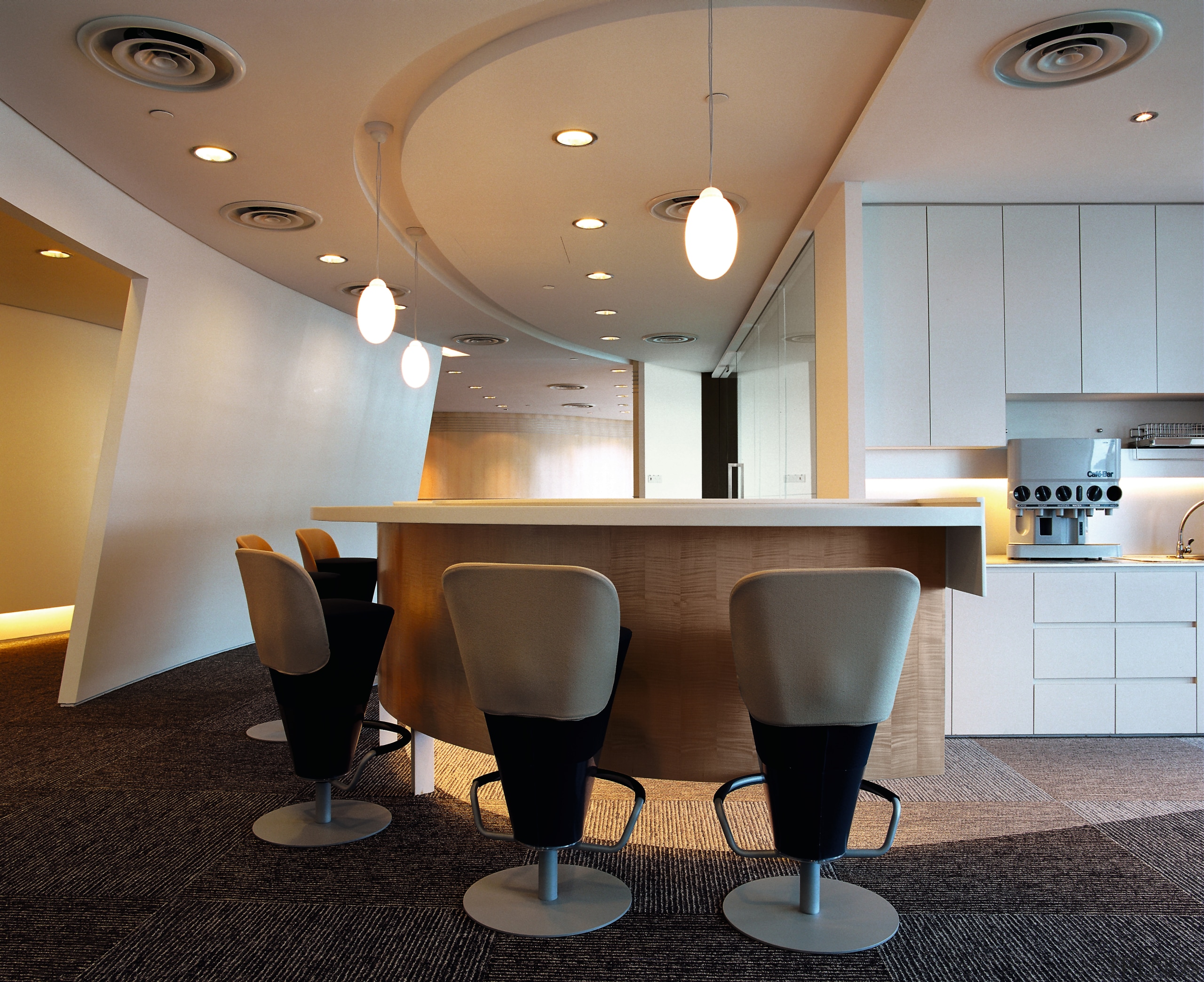 Office breakout area with stool chairs at curved ceiling, conference hall, furniture, interior design, light fixture, lighting, lobby, product design, table, gray