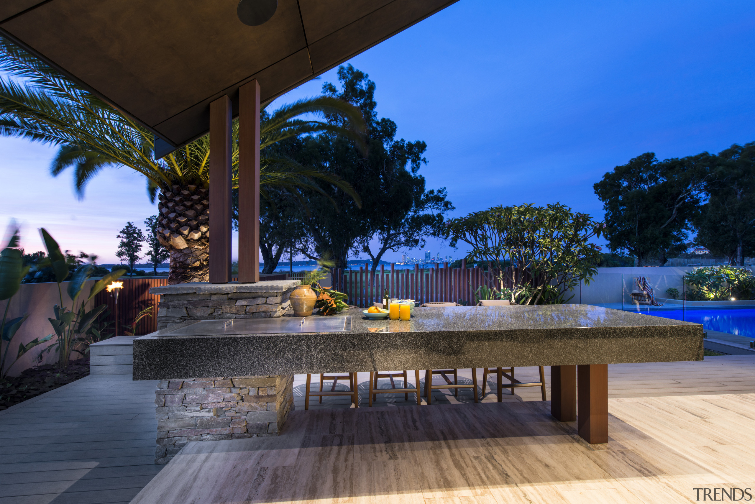 The barbecue is set in a granite-clad bench architecture, arecales, estate, home, house, landscape lighting, leisure, lighting, palm tree, property, real estate, resort, sky, swimming pool, vacation, villa, water, blue