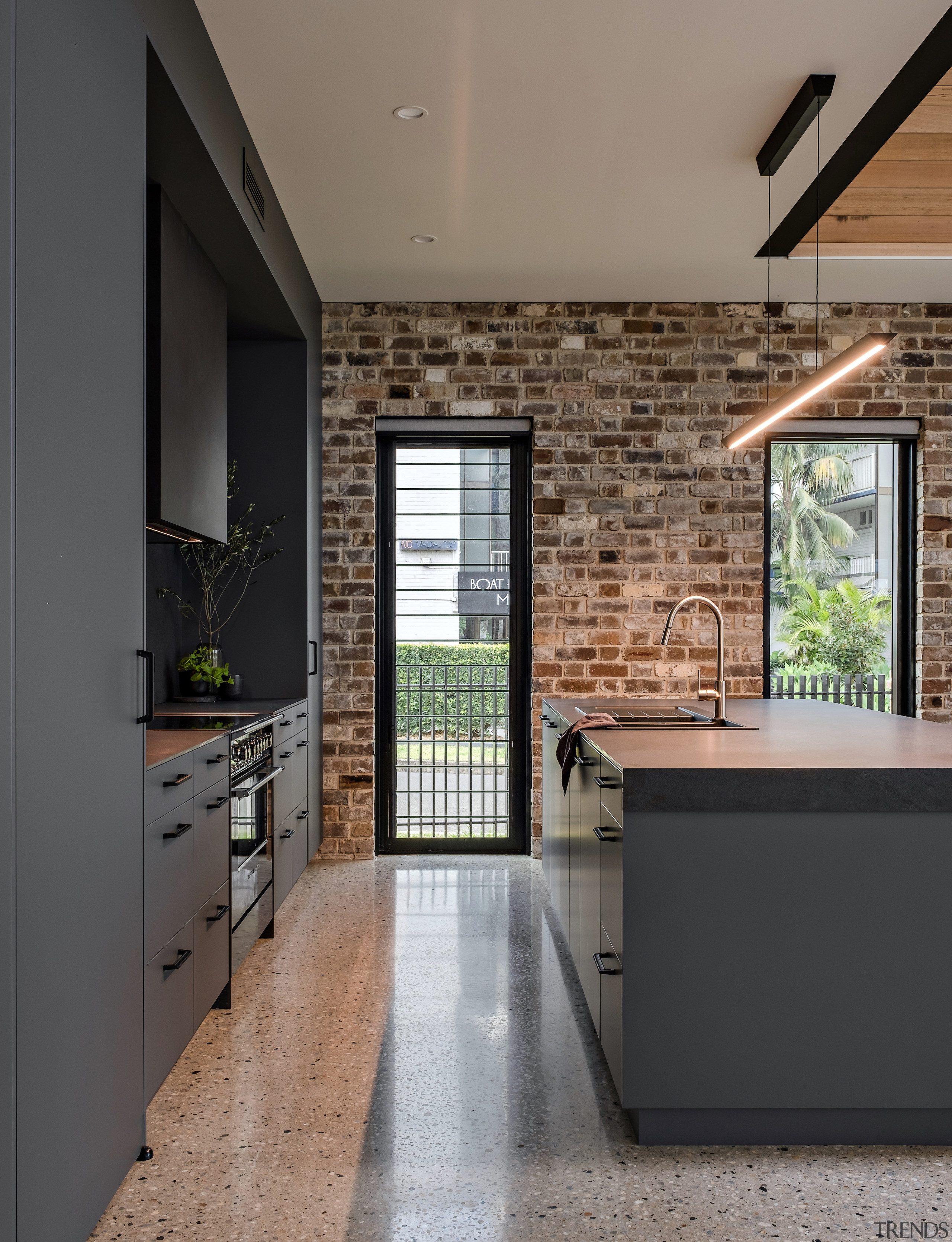 Kitchen and sculptural custom rangehood – concrete floors 