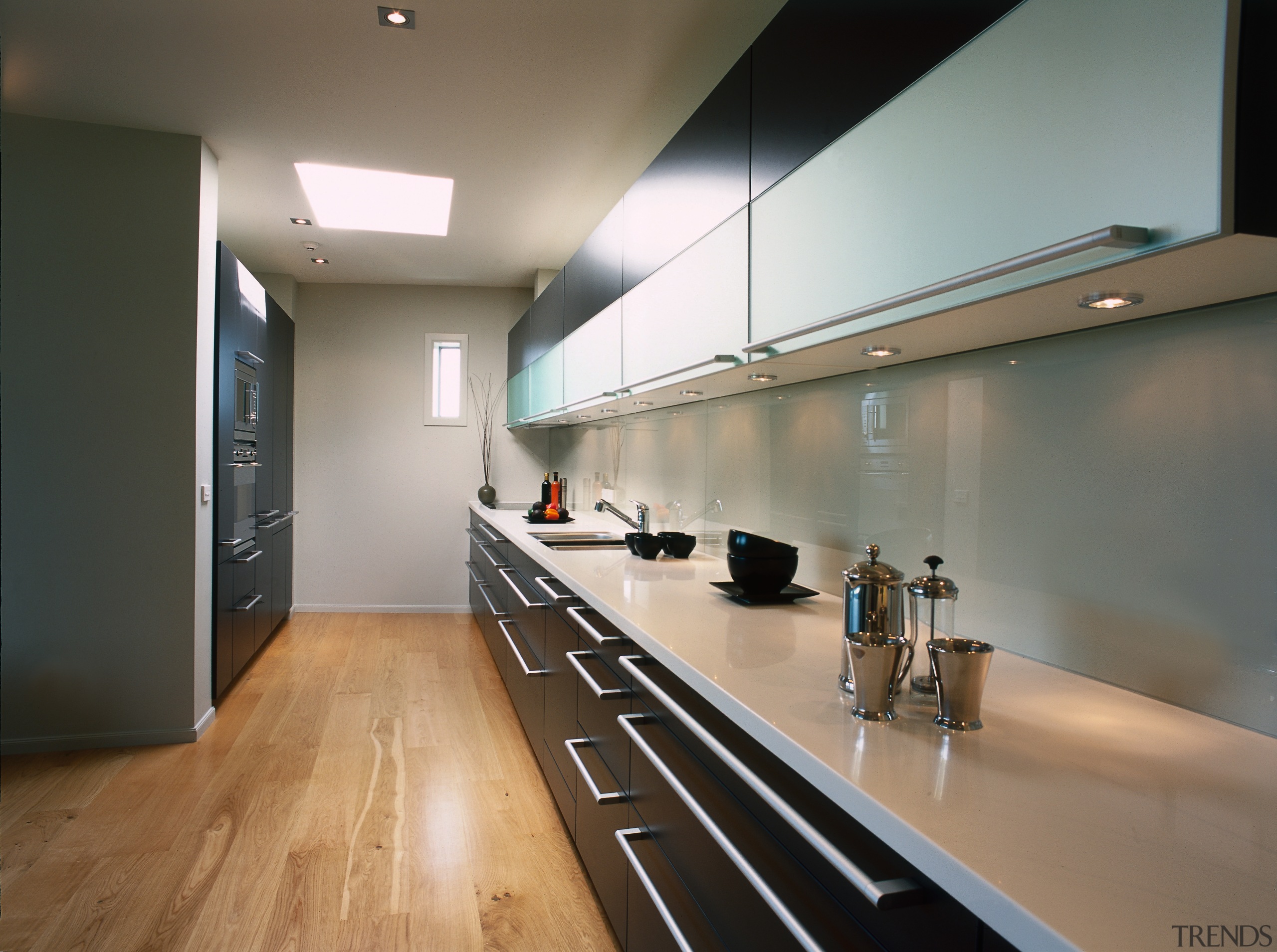 Kitchen with long white countertop and dark gray architecture, countertop, floor, flooring, glass, hardwood, interior design, wood, wood flooring, gray