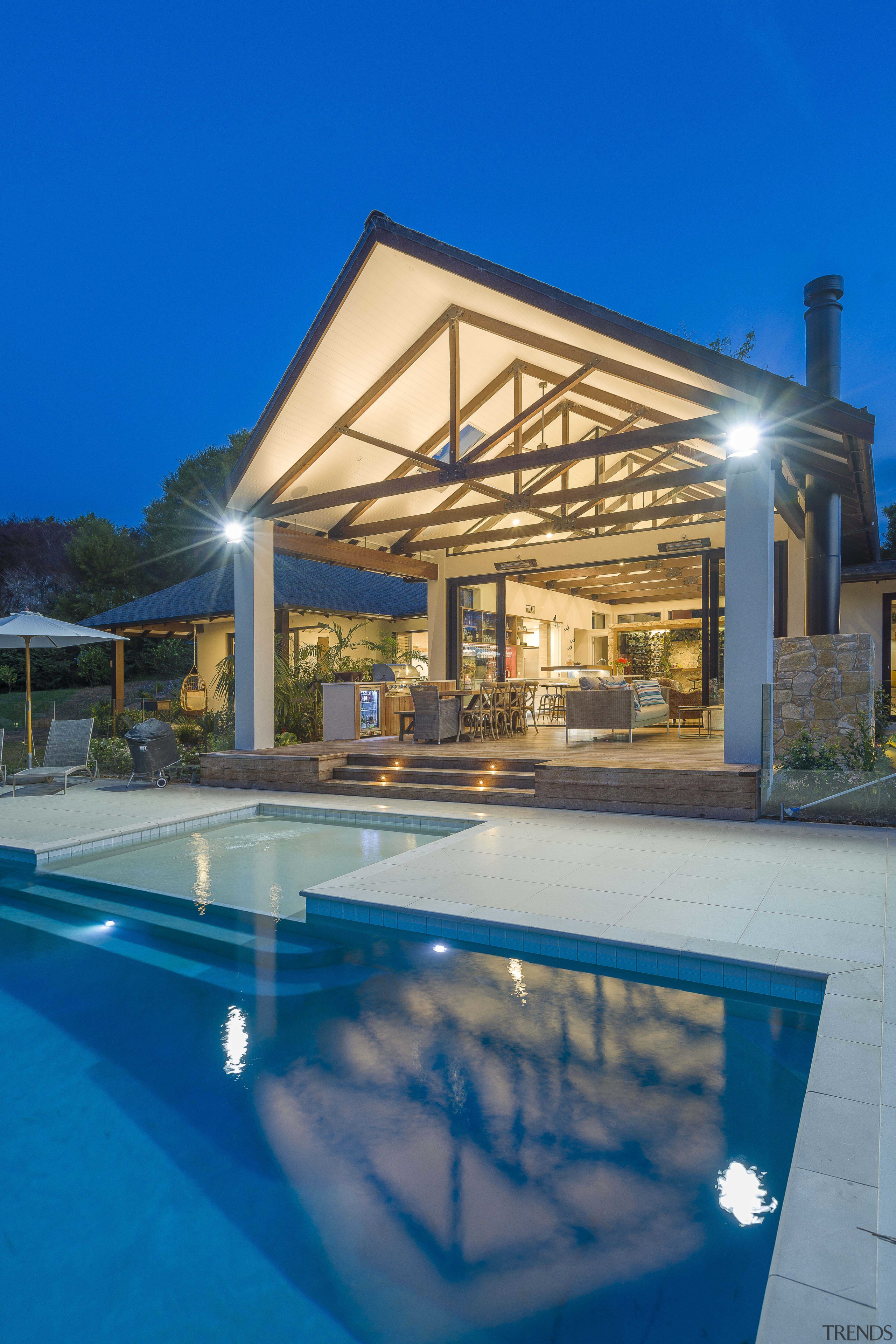 Timber ceiling beams help set the airy, tropical architecture, building, design, estate, home, house, leisure, lighting, patio, property, real estate, resort, roof, shade, swimming pool, villa, blue