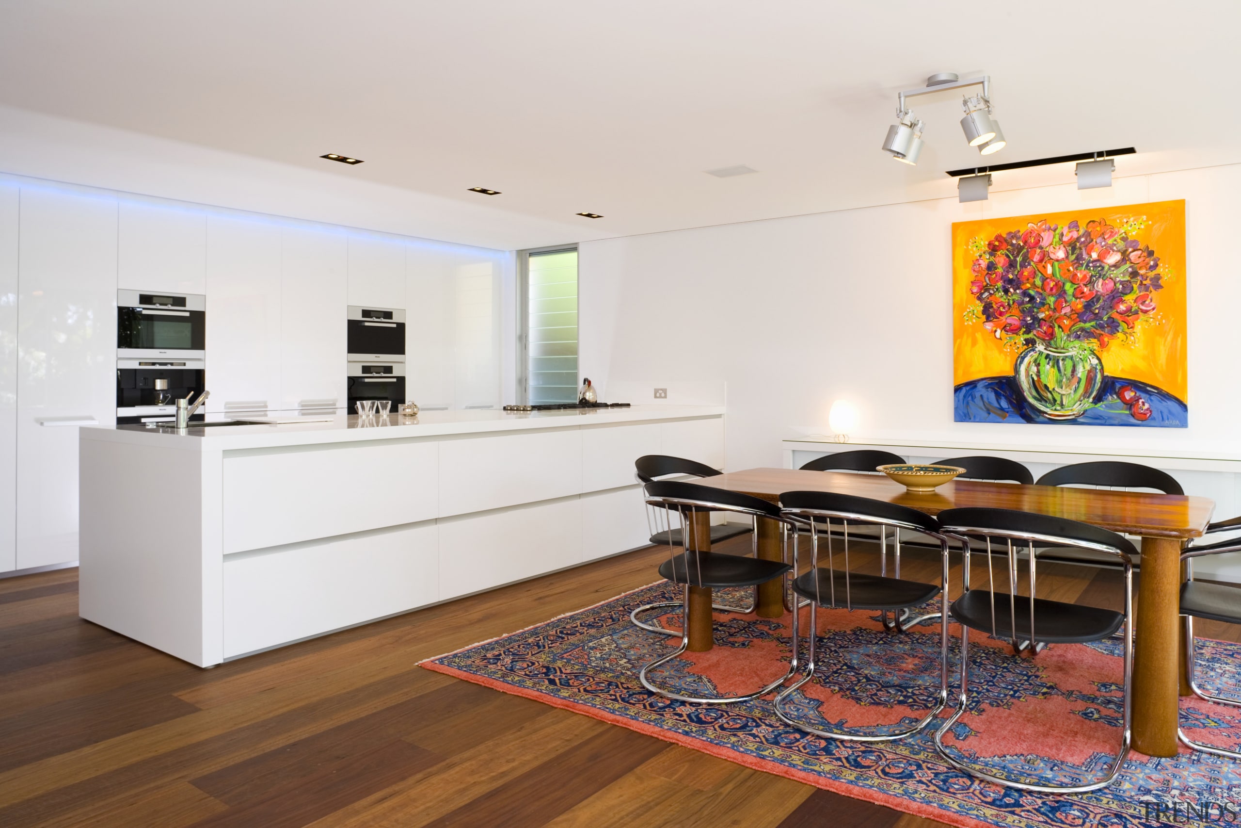 View of kitchen and dining area design by floor, flooring, furniture, interior design, living room, real estate, room, table, white