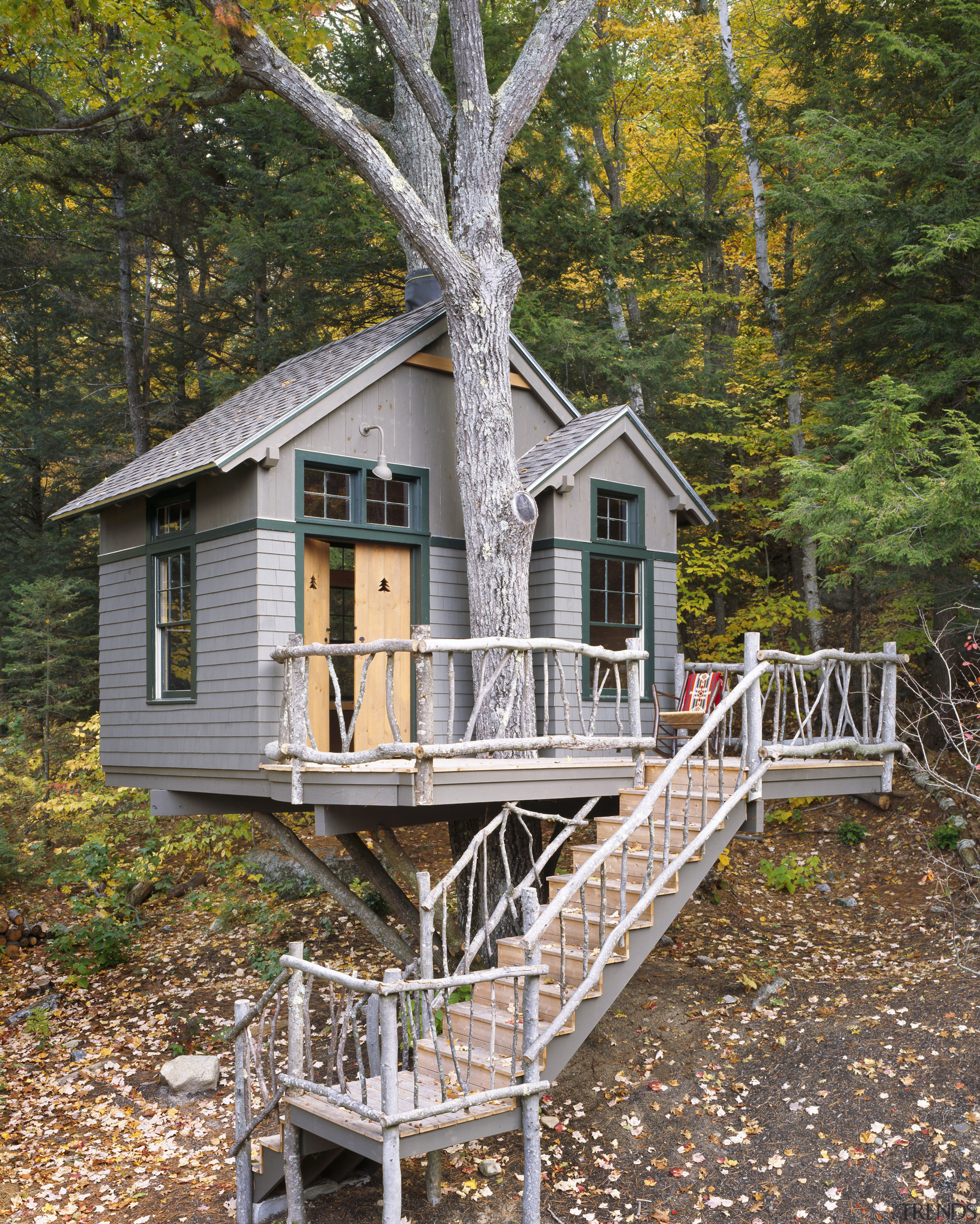 View of the holiday homes exterior featuring white building, cottage, home, house, log cabin, outdoor structure, plant, real estate, tree, tree house, wood, brown, gray