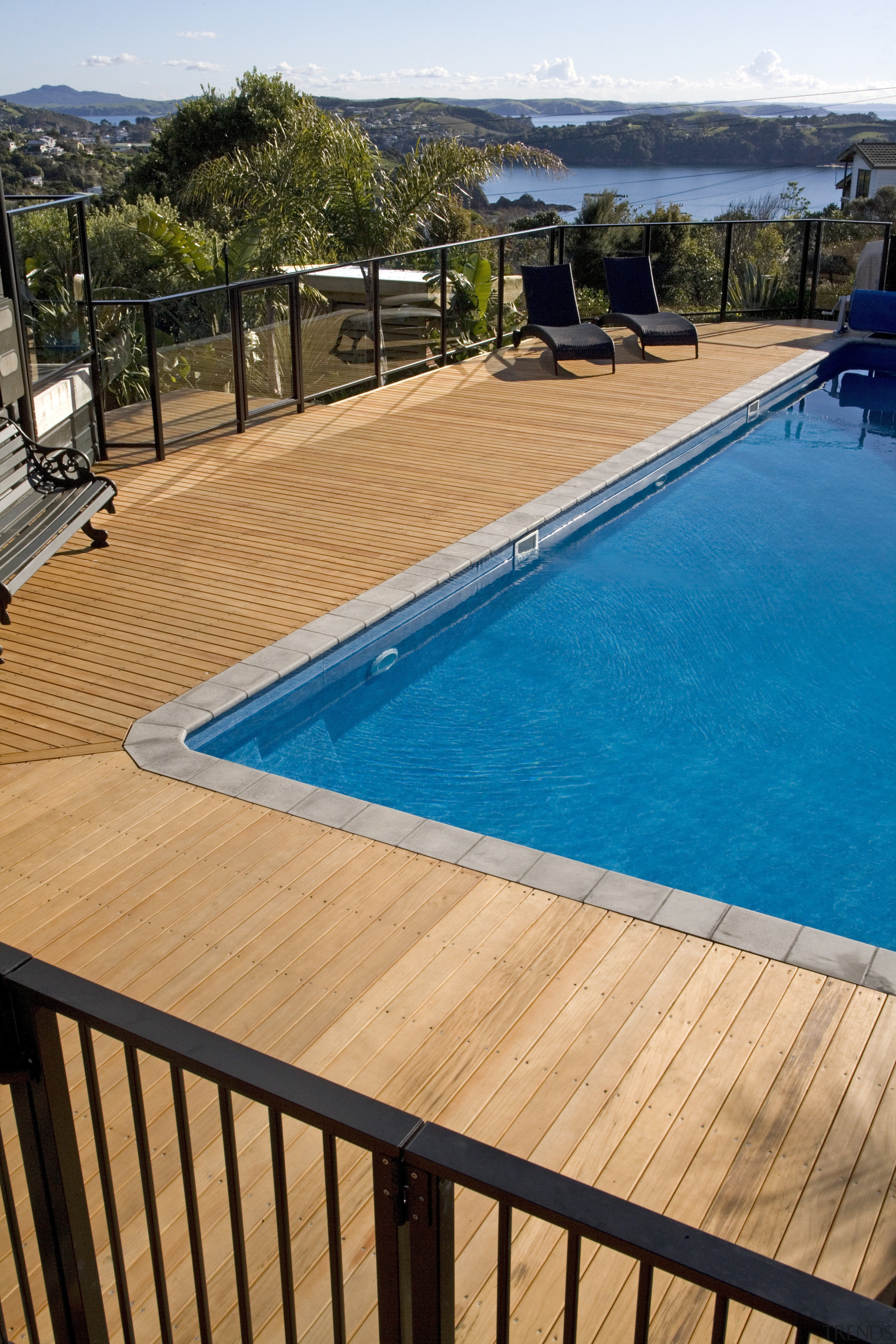 view of a pool area which features pre-finished deck, leisure, outdoor structure, property, real estate, resort, swimming pool, water, wood, orange