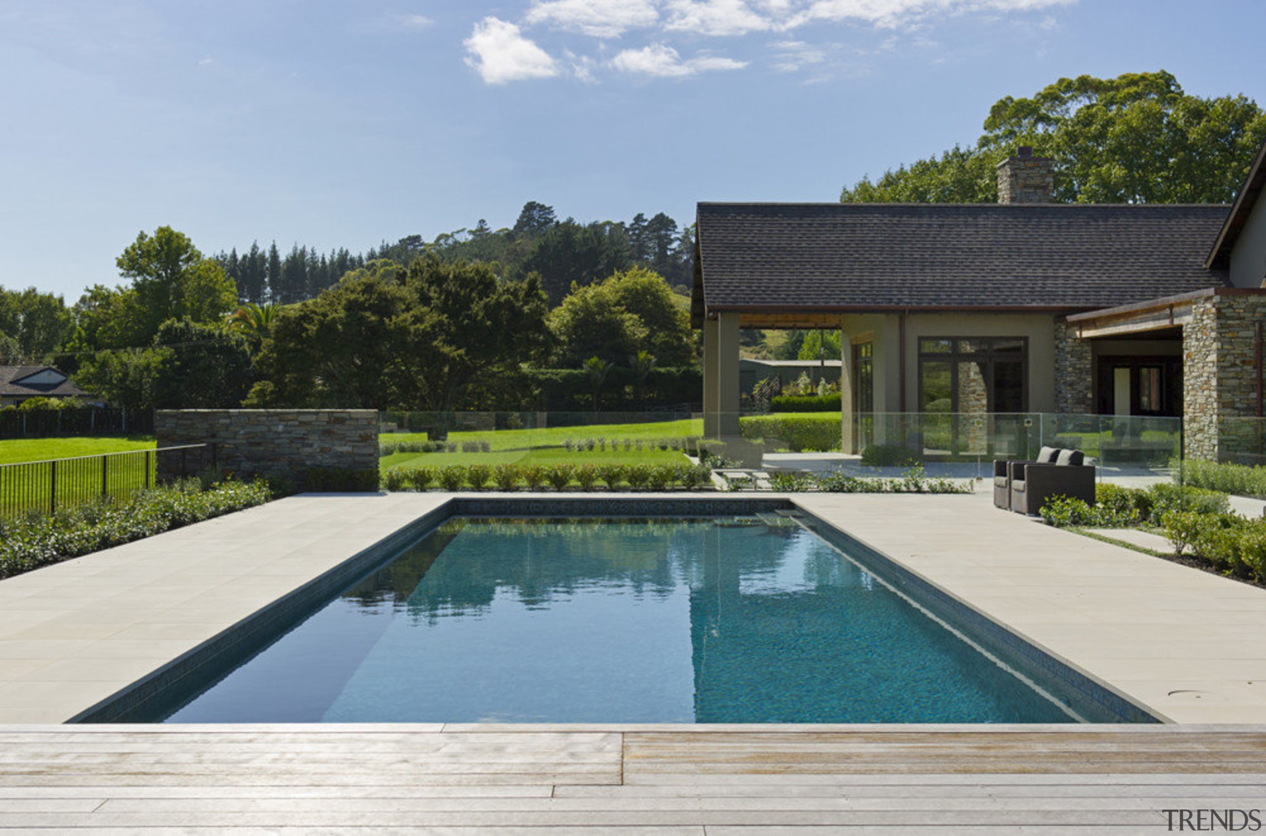 View of pool area with house behind. - backyard, cottage, estate, home, house, landscape, landscaping, leisure, property, real estate, resort, swimming pool, villa, teal