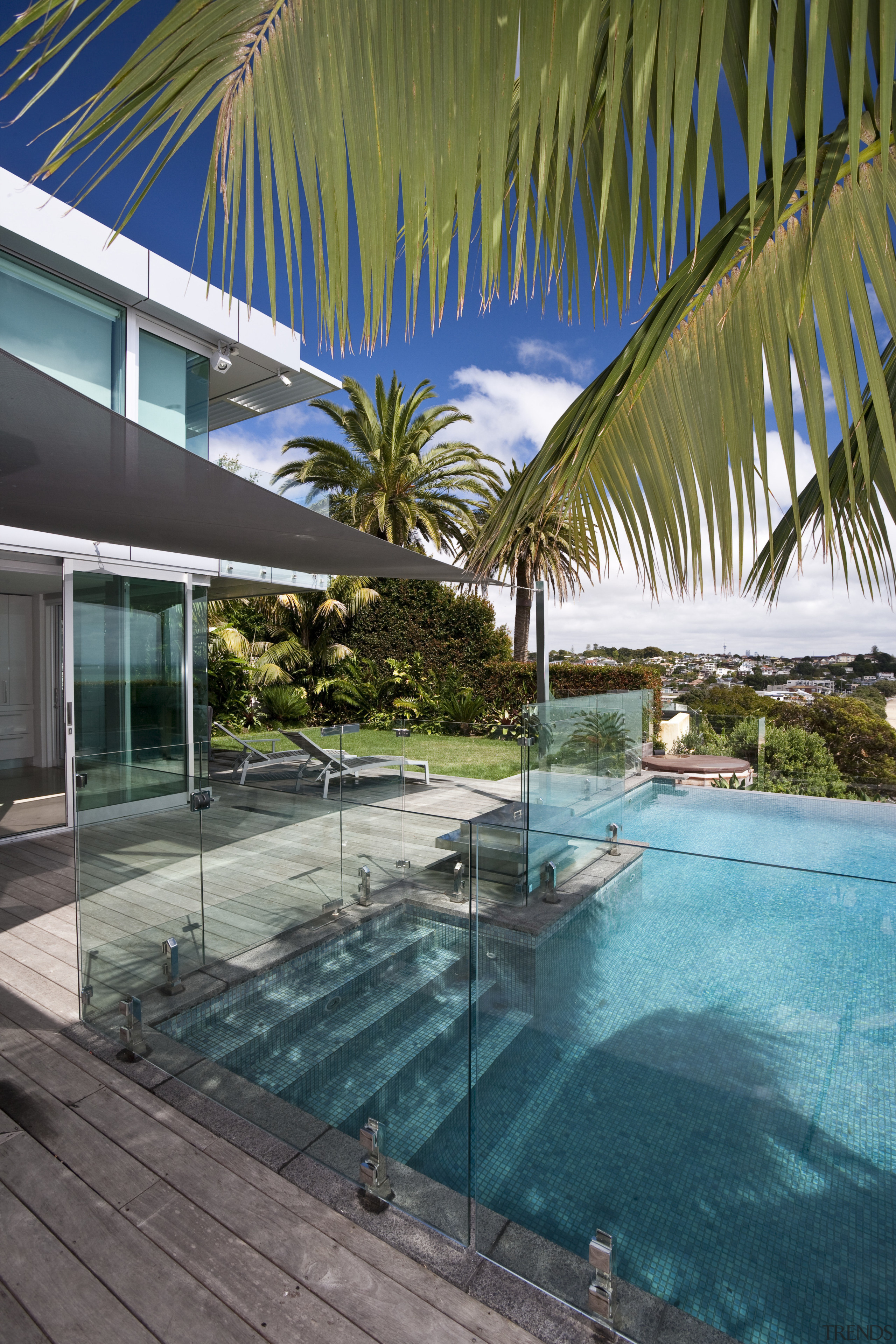 View of a pool area which features glass architecture, arecales, caribbean, estate, house, leisure, palm tree, property, real estate, resort, resort town, sky, swimming pool, tropics, vacation, villa, water, brown