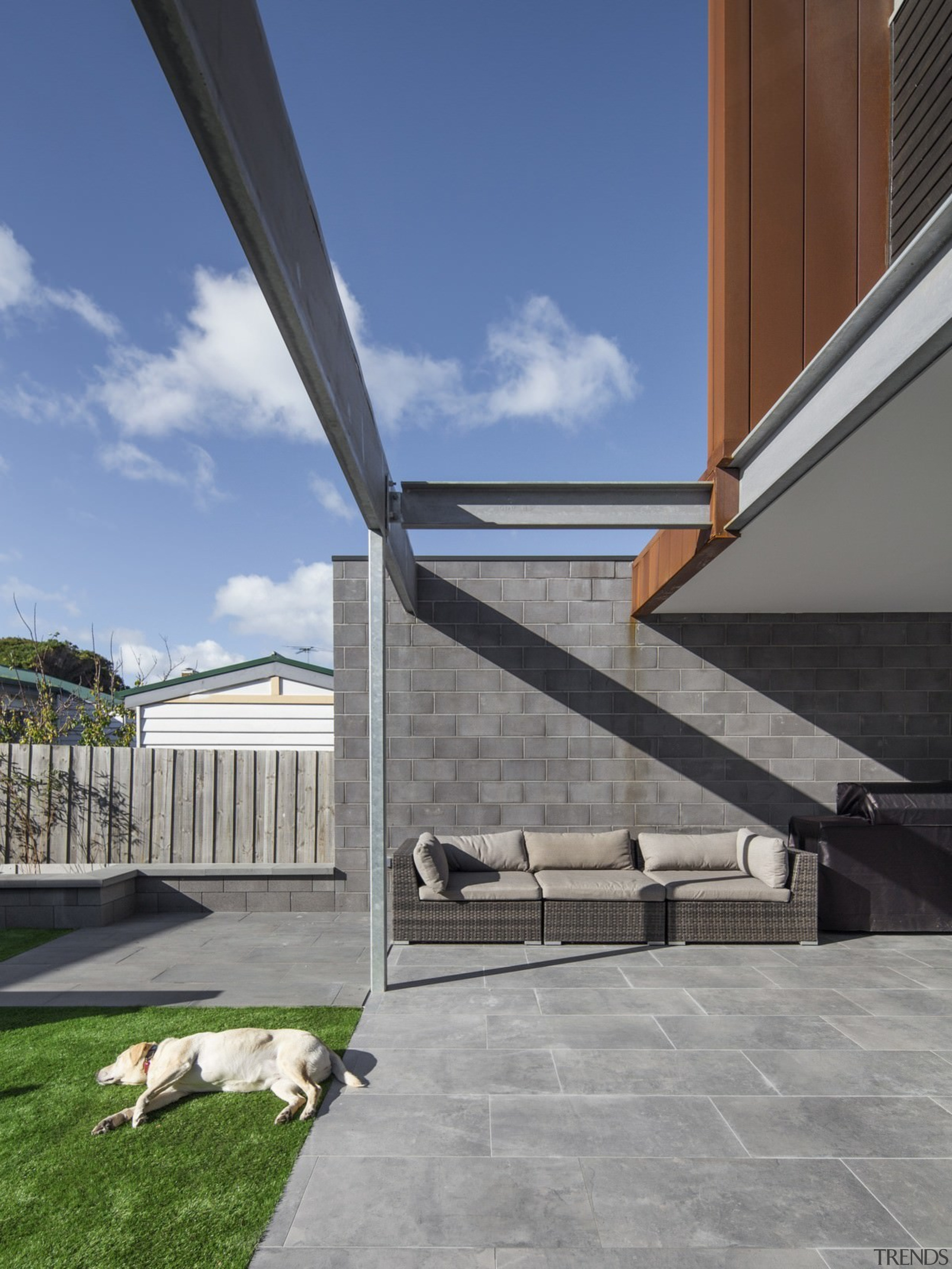 This comfortable outdoor area extends out from the architecture, building, daylighting, house, roof, sky, structure, gray