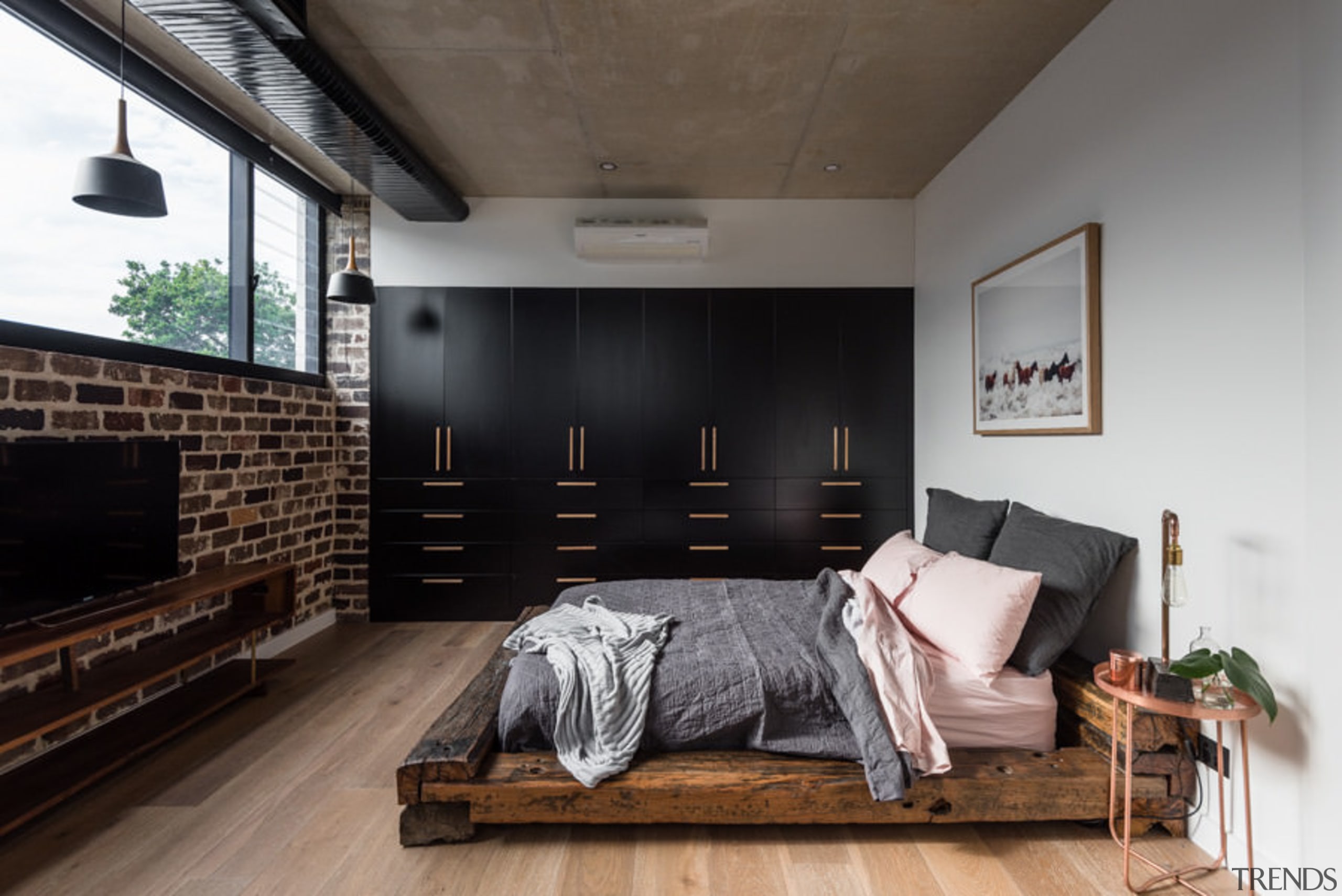 The bed in this room seems to fit architecture, floor, furniture, house, interior design, living room, loft, room, wood, black