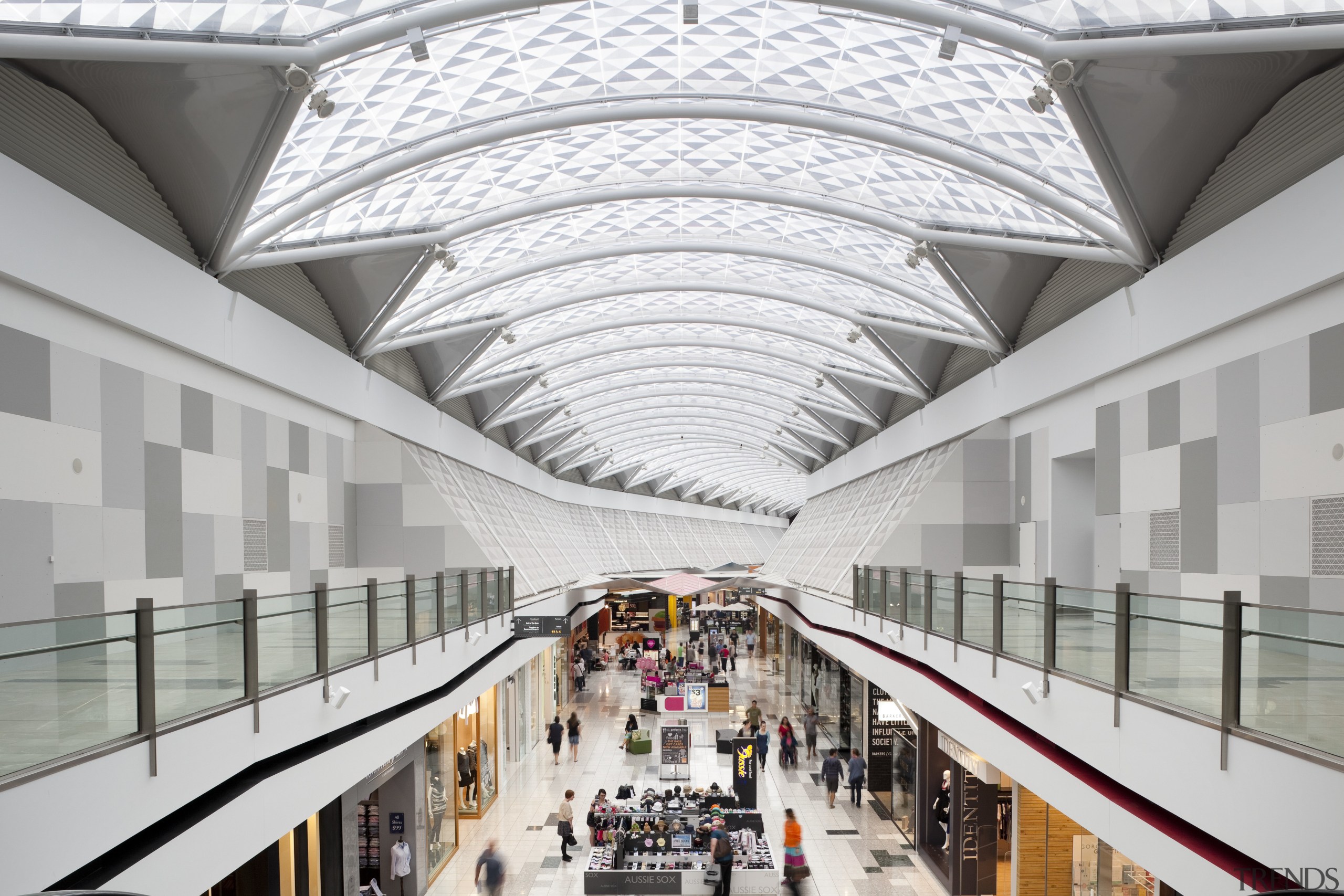 View of light toned interior of mall. - architecture, building, daylighting, metropolitan area, mixed use, shopping mall, tourist attraction, white, gray