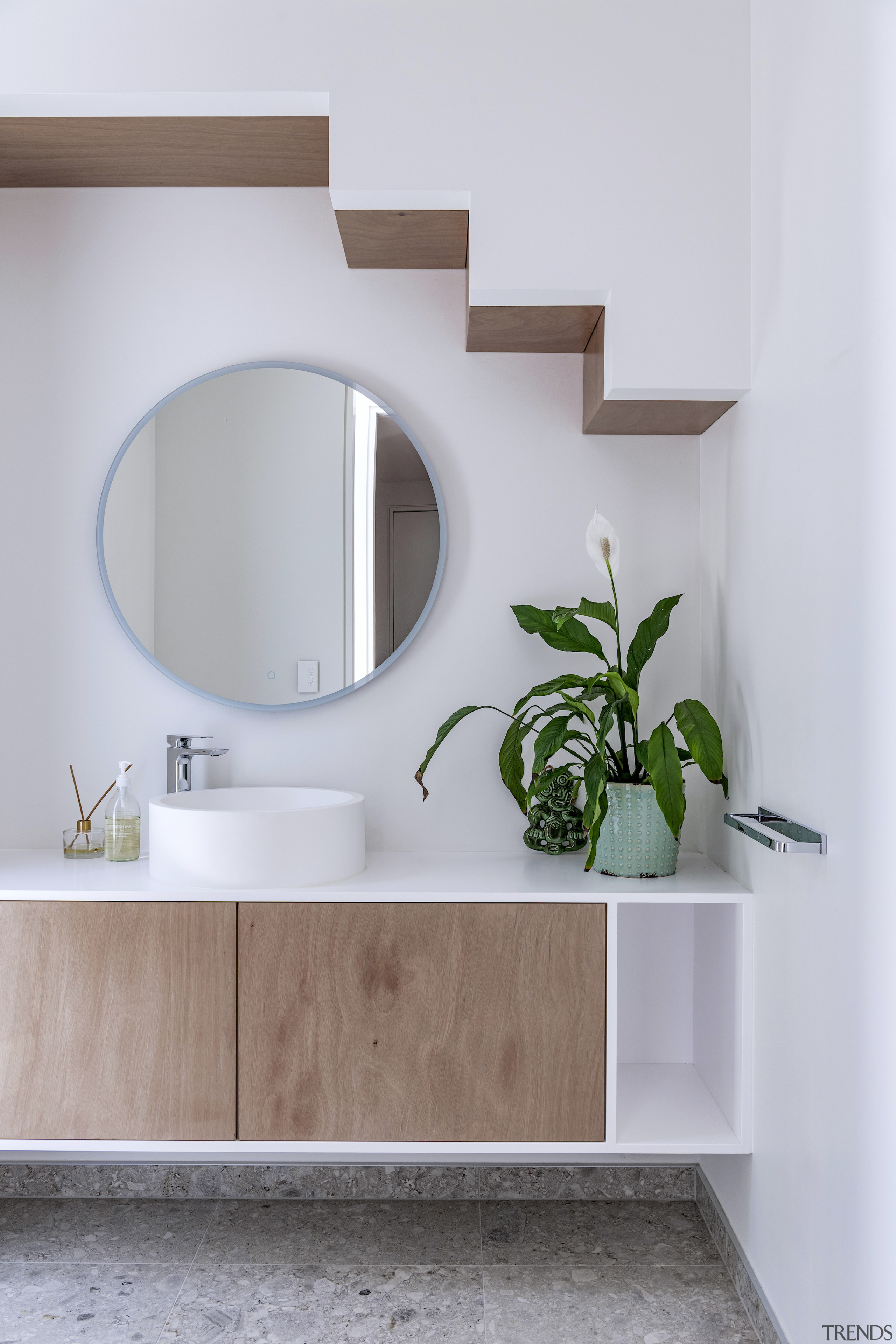 Bathroom vanity with intimations of the staircase above. 