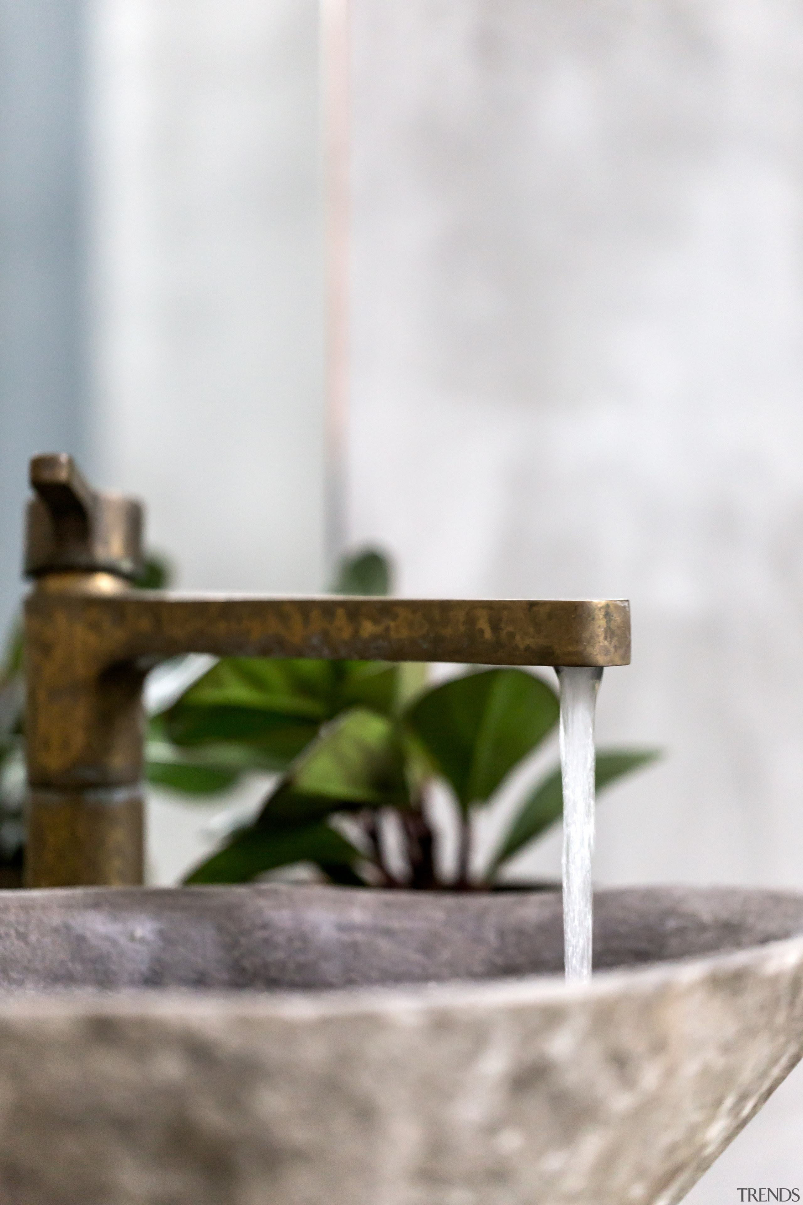 ​​​​​​​Burnished brass tapware paired with a granite basin brass tapware, Arc Seven, bathroom design