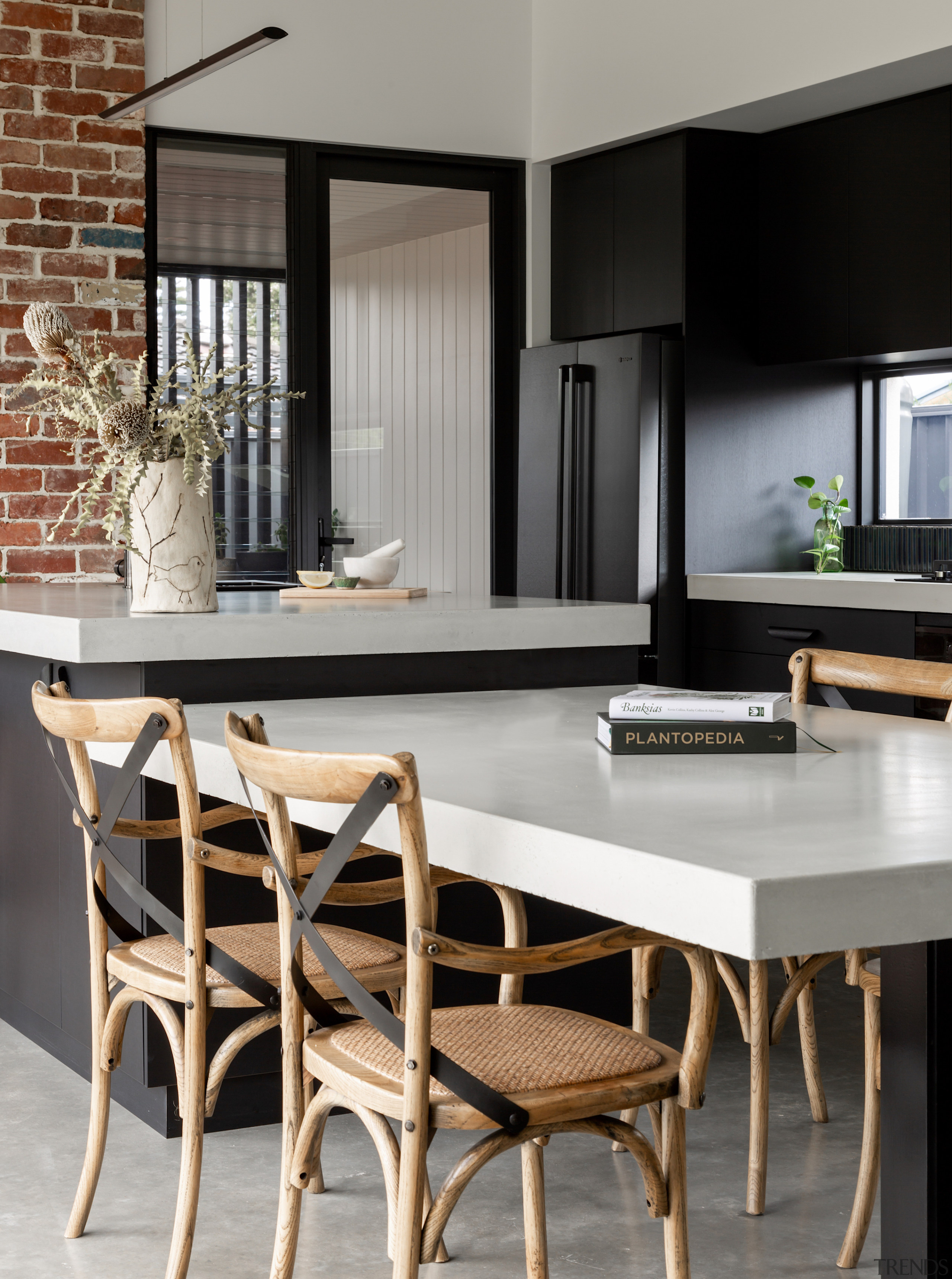 The kitchen and dining table have chunky benchtops, 
