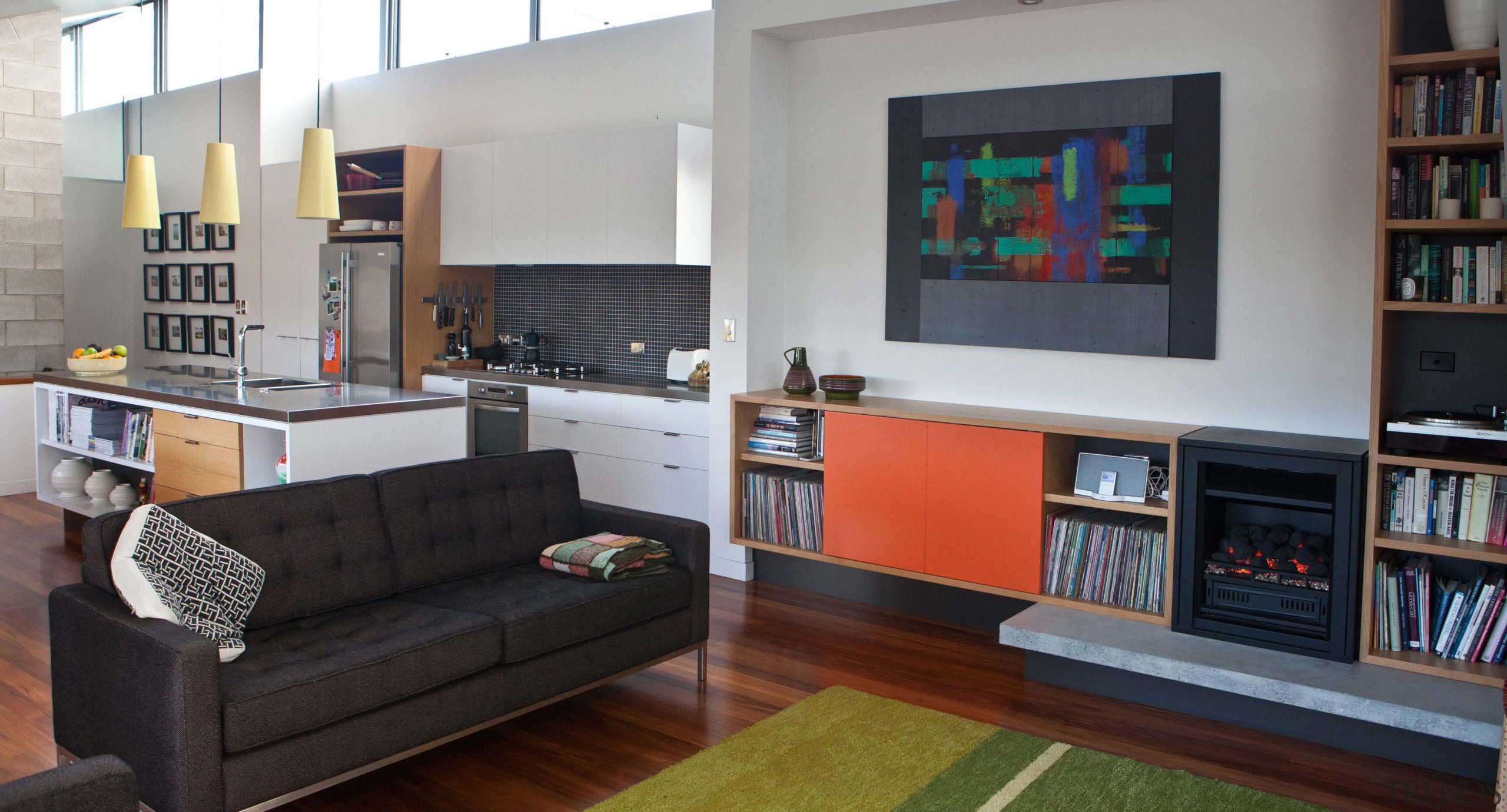 The new cabinetry uses a restained pallet of bookcase, furniture, interior design, living room, room, shelving, gray, black