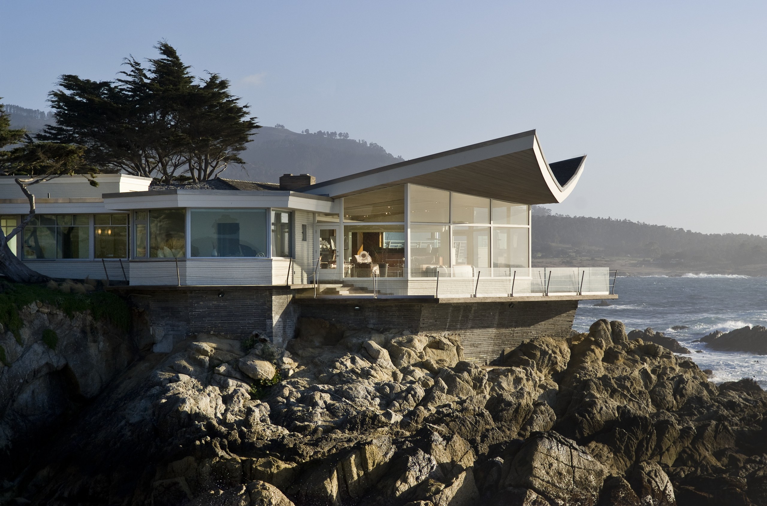 View of the oceanfront Butterfly House in Carmel architecture, building, cottage, home, house, property, real estate, reflection, sky, water, black, gray