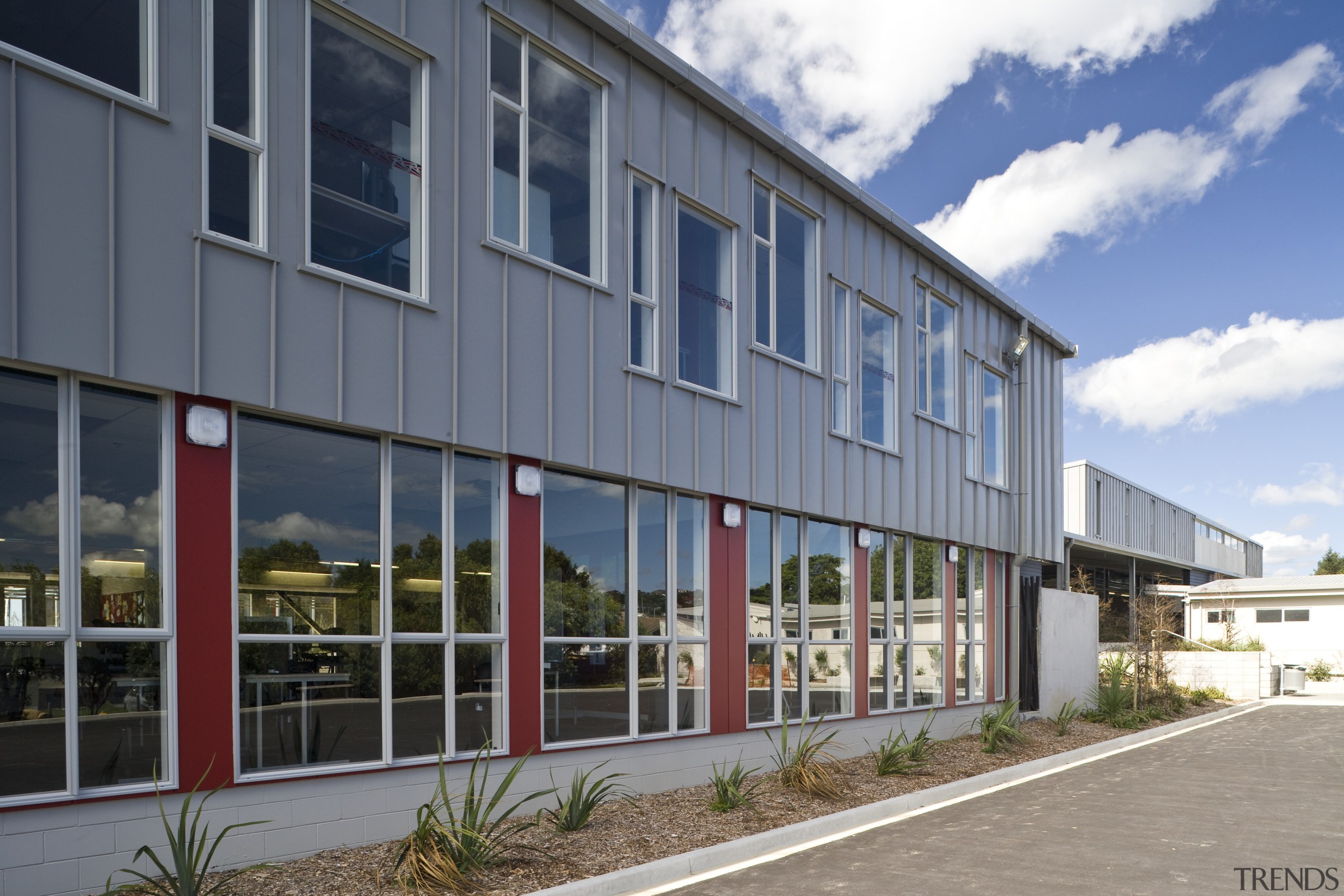 Exterior view of school which features cladding manufactured building, commercial building, corporate headquarters, facade, house, mixed use, property, real estate, gray