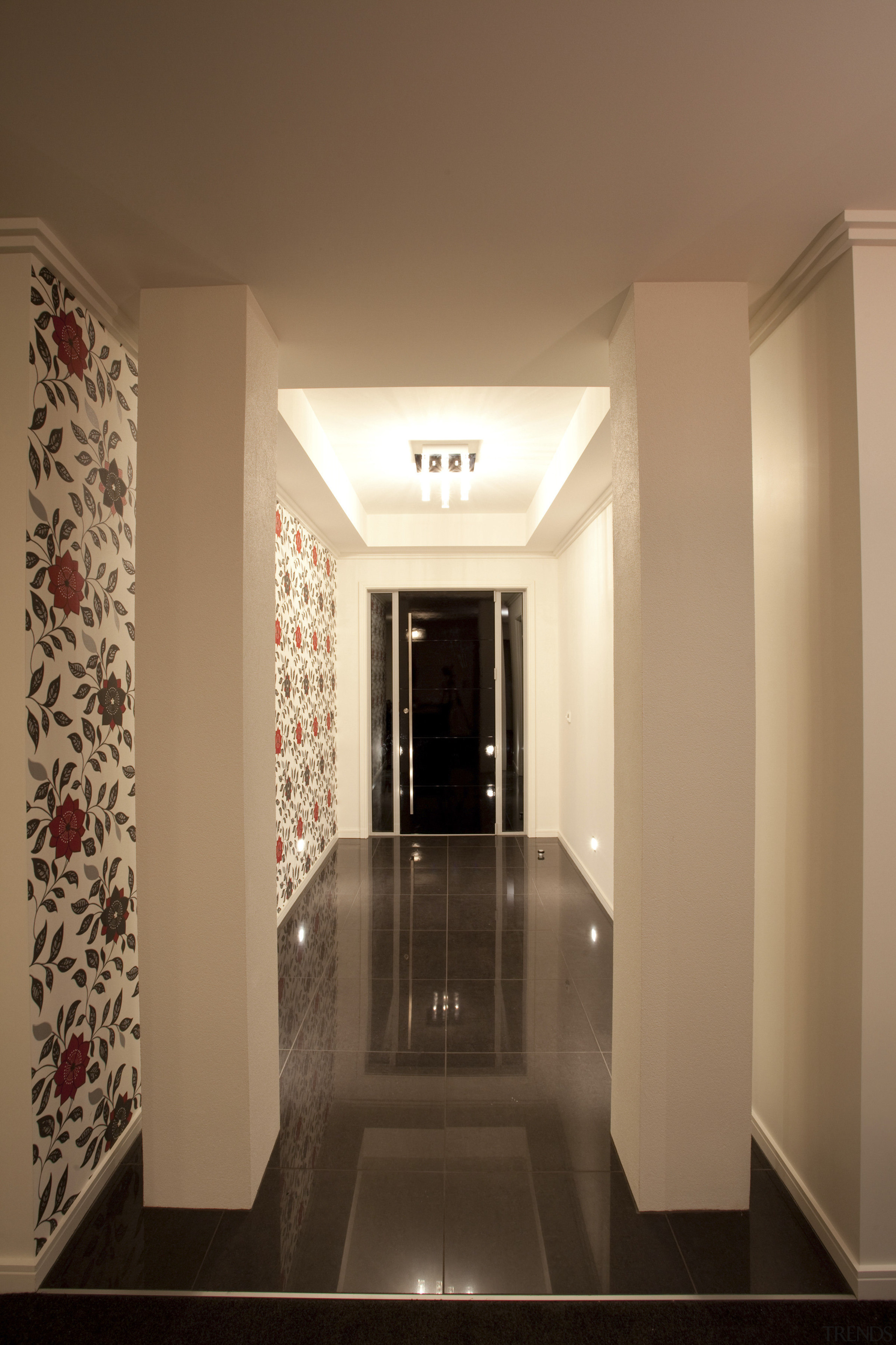 View of hallway and front door which features apartment, ceiling, floor, flooring, hall, home, interior design, lighting, lobby, room, wall, brown, orange