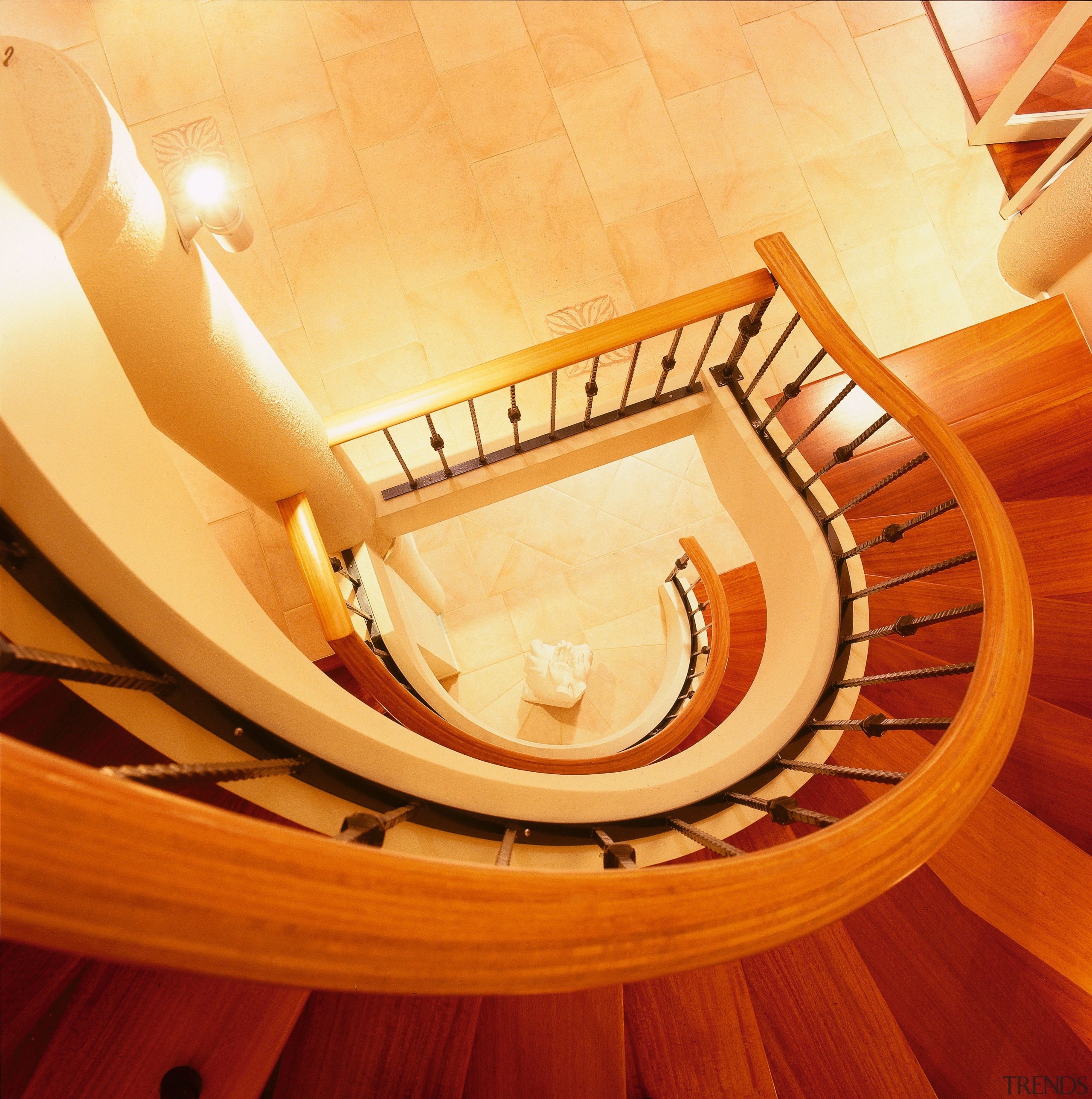 Large curved staircase with wooden steps linking three ceiling, floor, flooring, hardwood, orange, product design, wood, orange