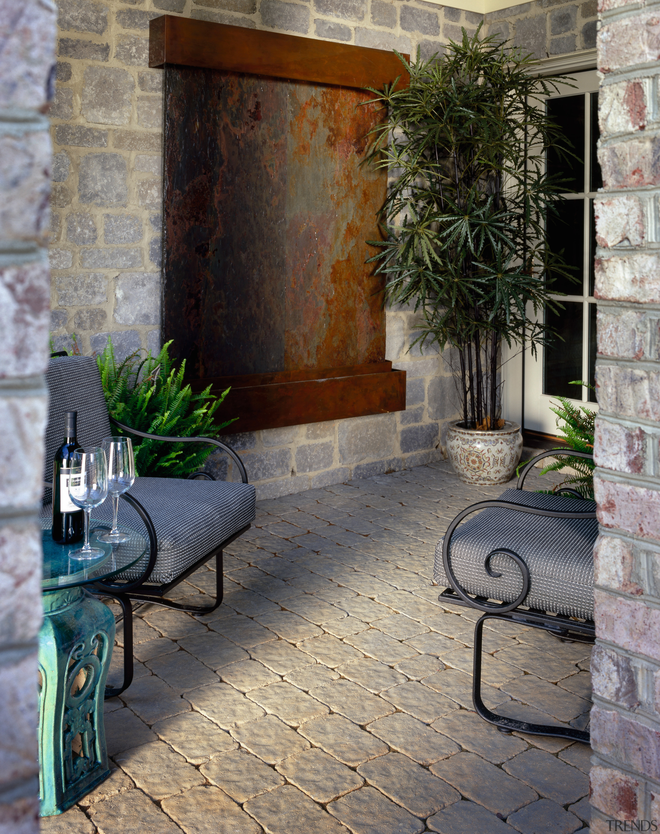 View of patio area with sandstone coloured pavers, brick, courtyard, facade, home, outdoor structure, patio, porch, walkway, wall, window, gray