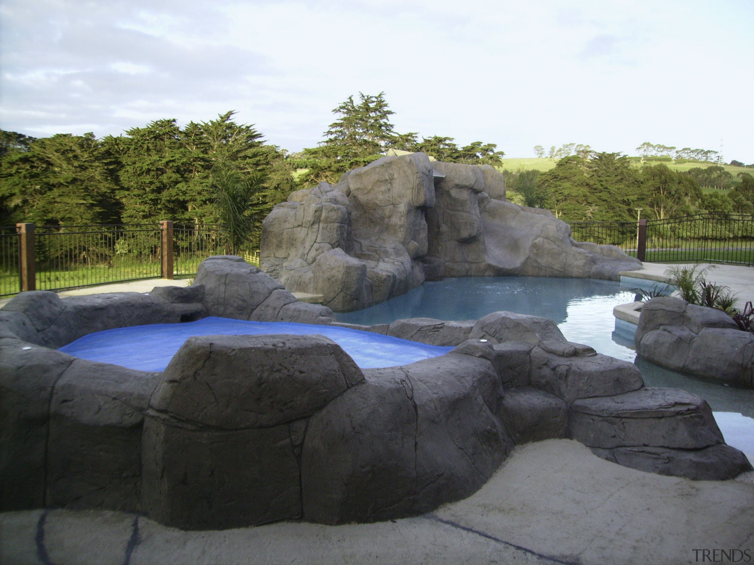 Natural looking pool &amp; spa area - Natural landscape, pond, rock, swimming pool, water, water feature, water resources, watercourse, black, white
