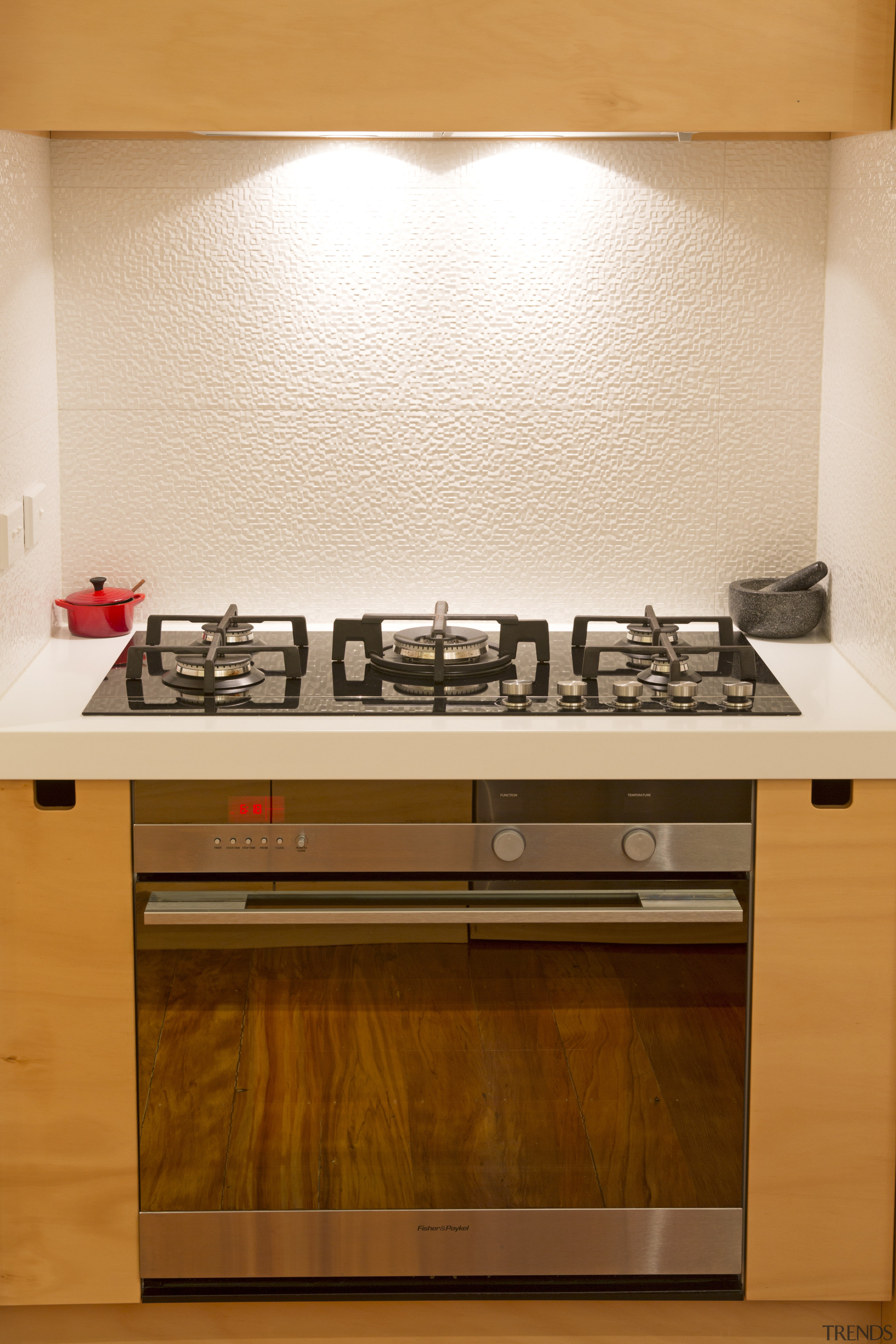 Toni Roberts kitchen with Fisher &amp; Paykel appliances. cabinetry, countertop, floor, flooring, hardwood, interior design, kitchen, kitchen stove, room, under cabinet lighting, orange, brown, white