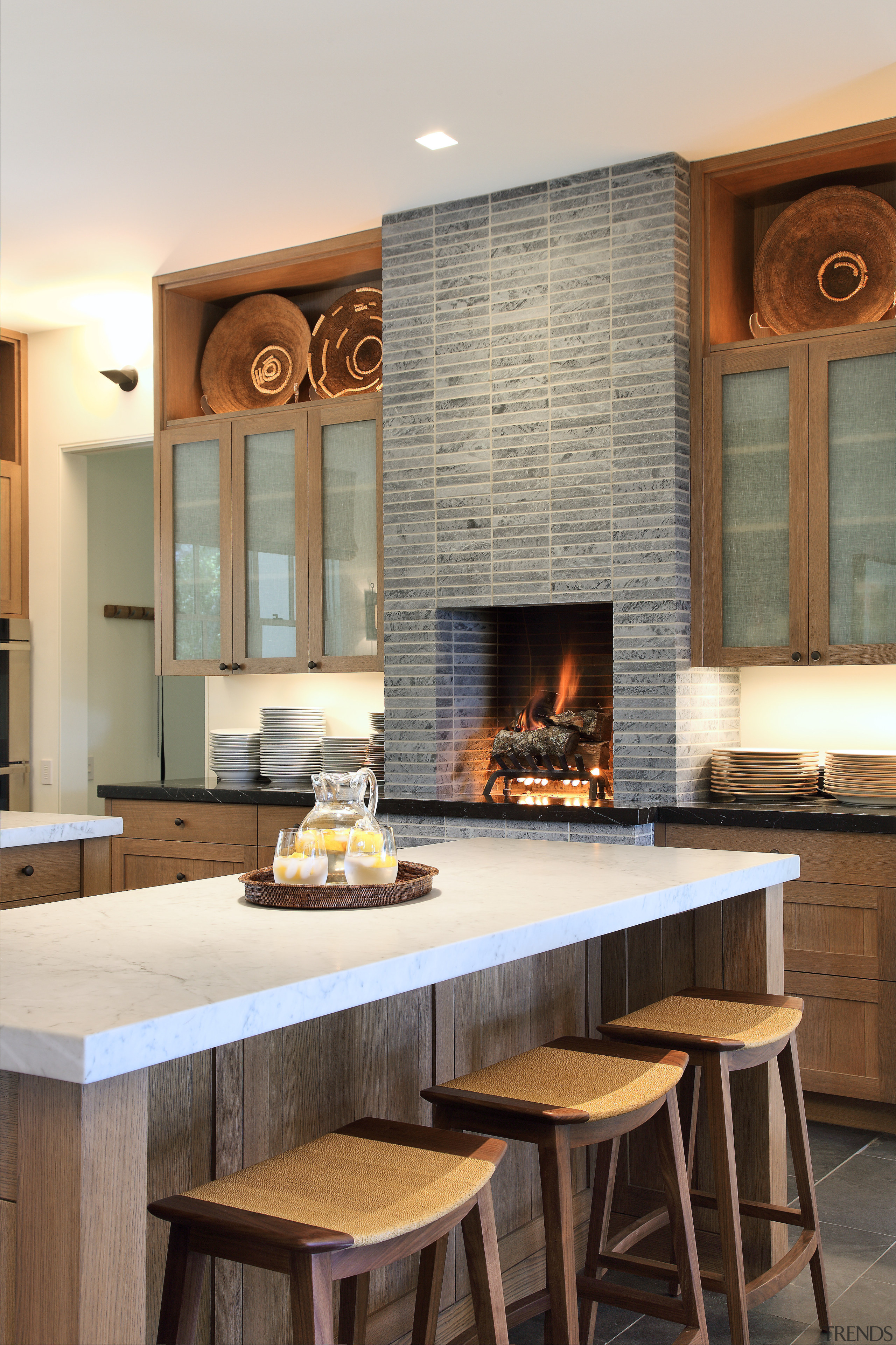 Kitchen with fireplace and island with white benchtops countertop, fireplace, flooring, hearth, interior design, kitchen, white, brown