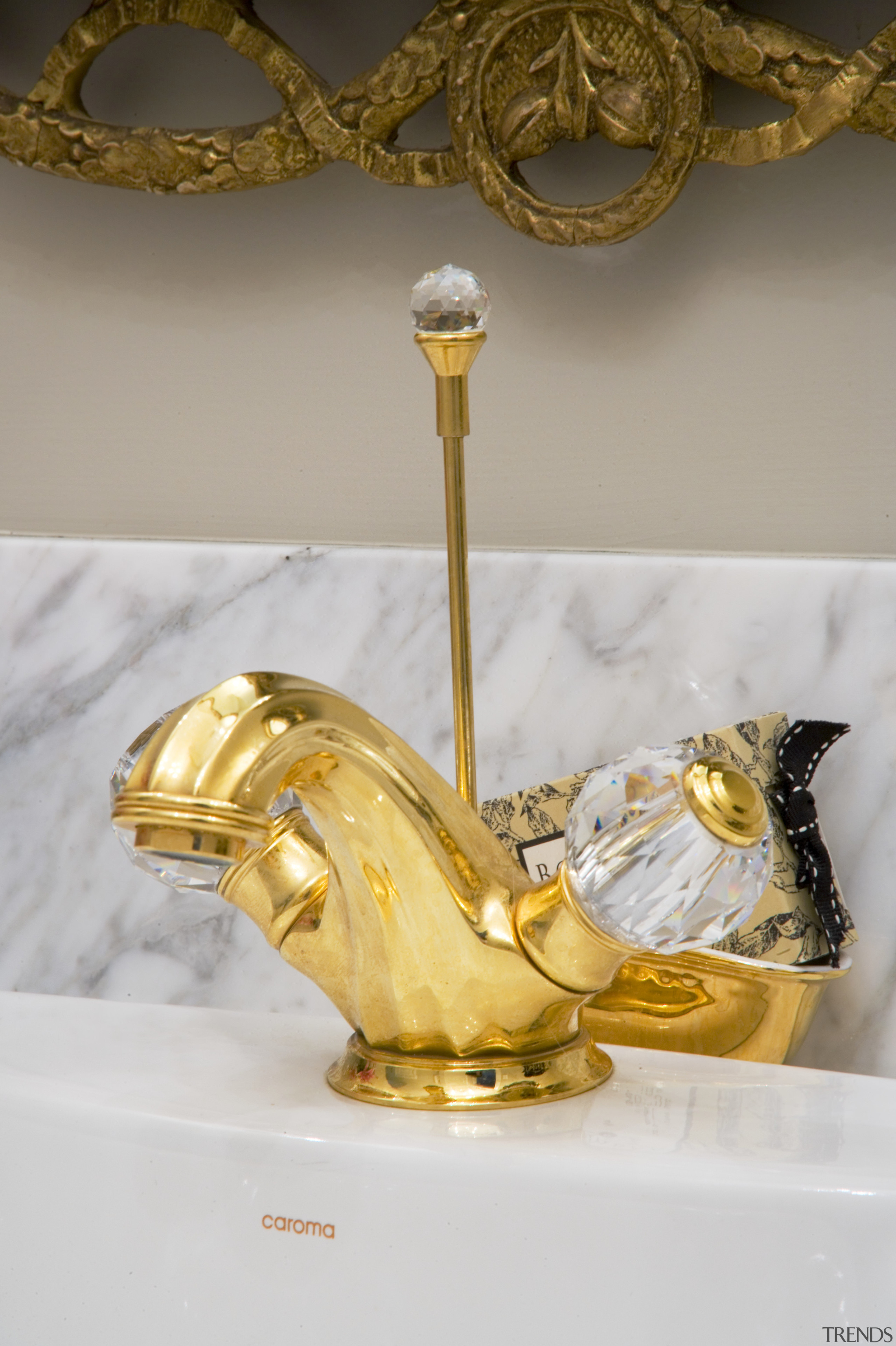 The luxurious theme is continued with the ornate brass, gold, material, metal, gray