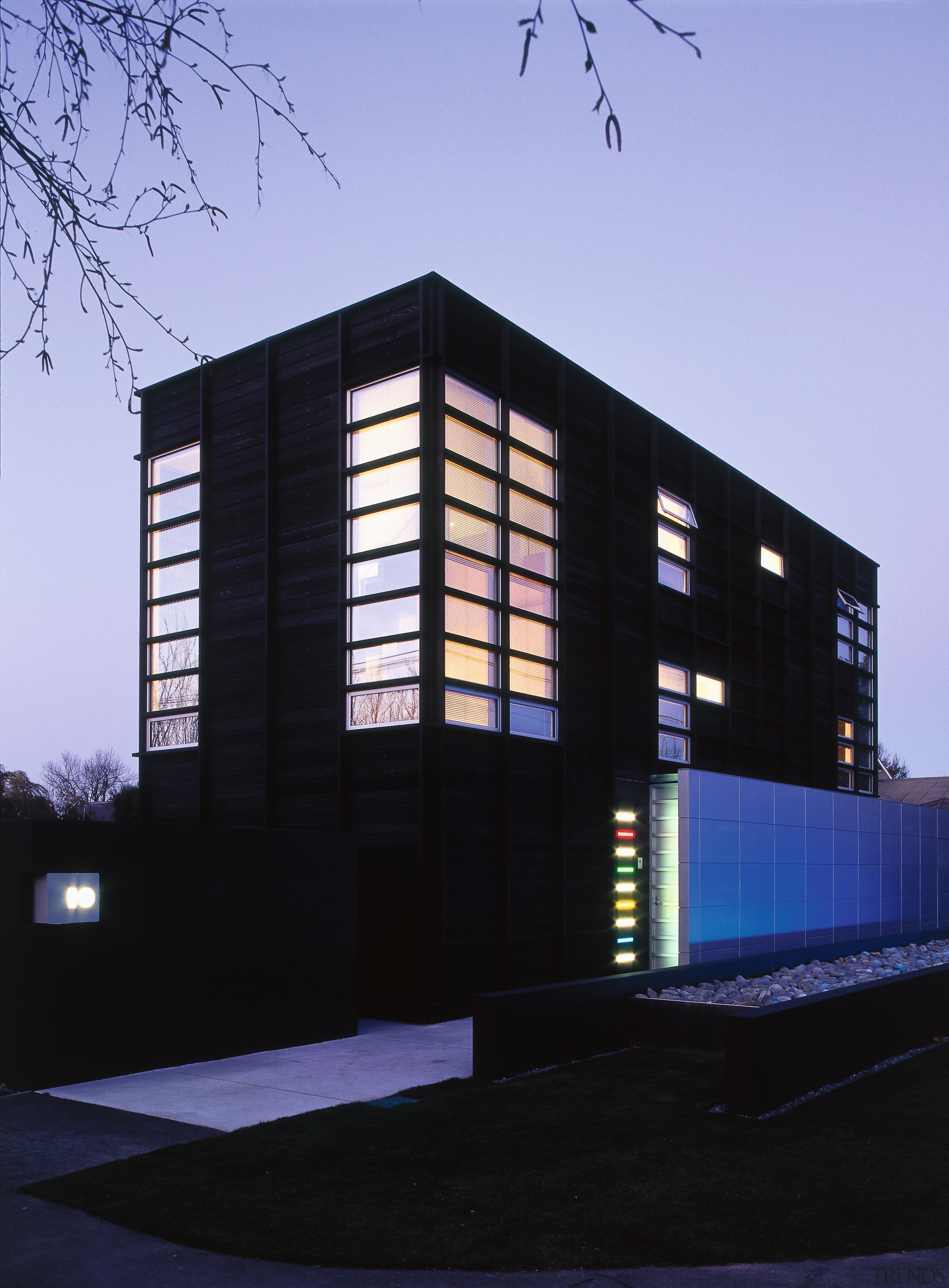 An exterior view of this contemporary home designed architecture, building, commercial building, corporate headquarters, facade, headquarters, house, night, residential area, sky, structure, black, blue