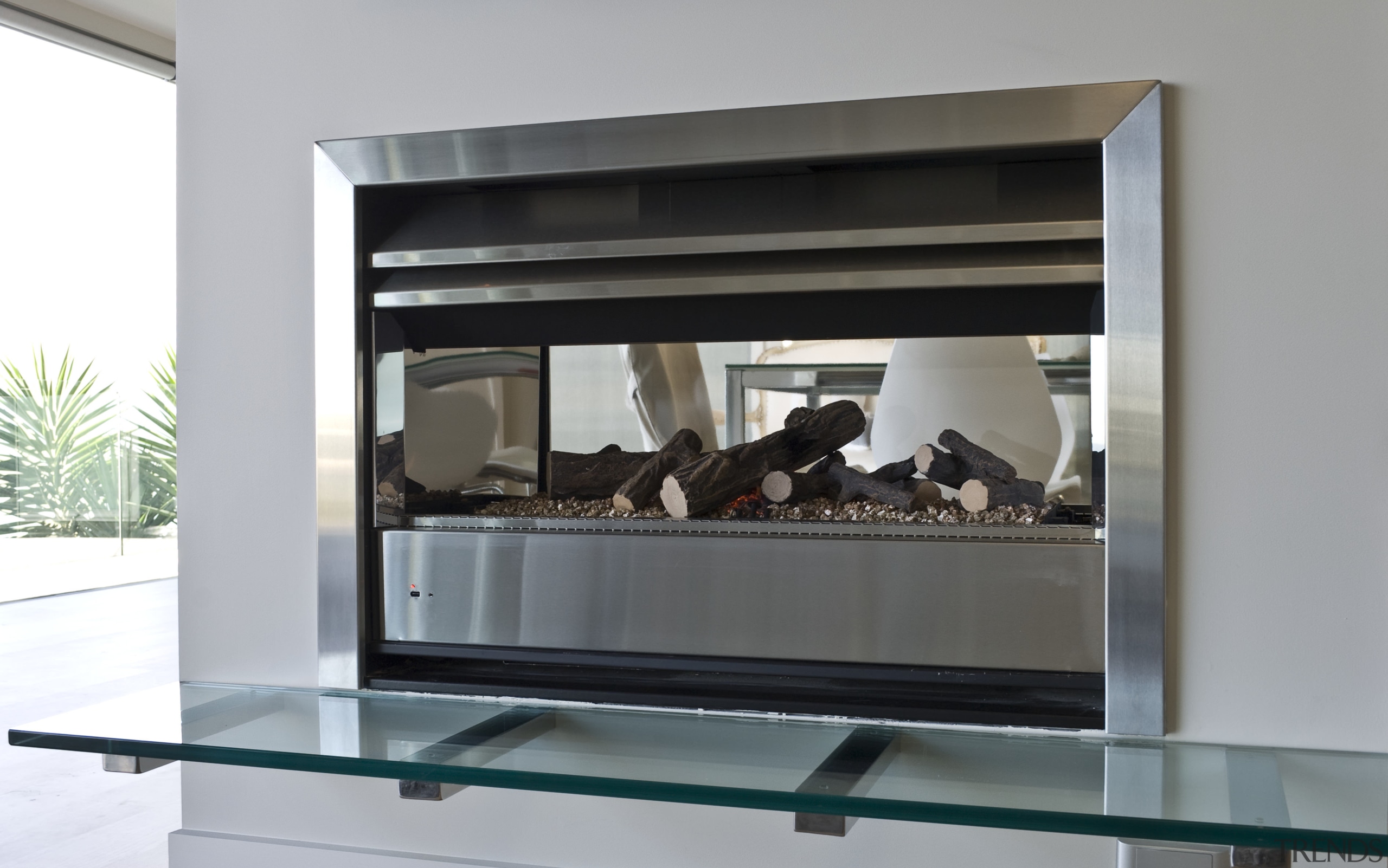 View of the Through Wall Minimal fireplace from display case, furniture, gray
