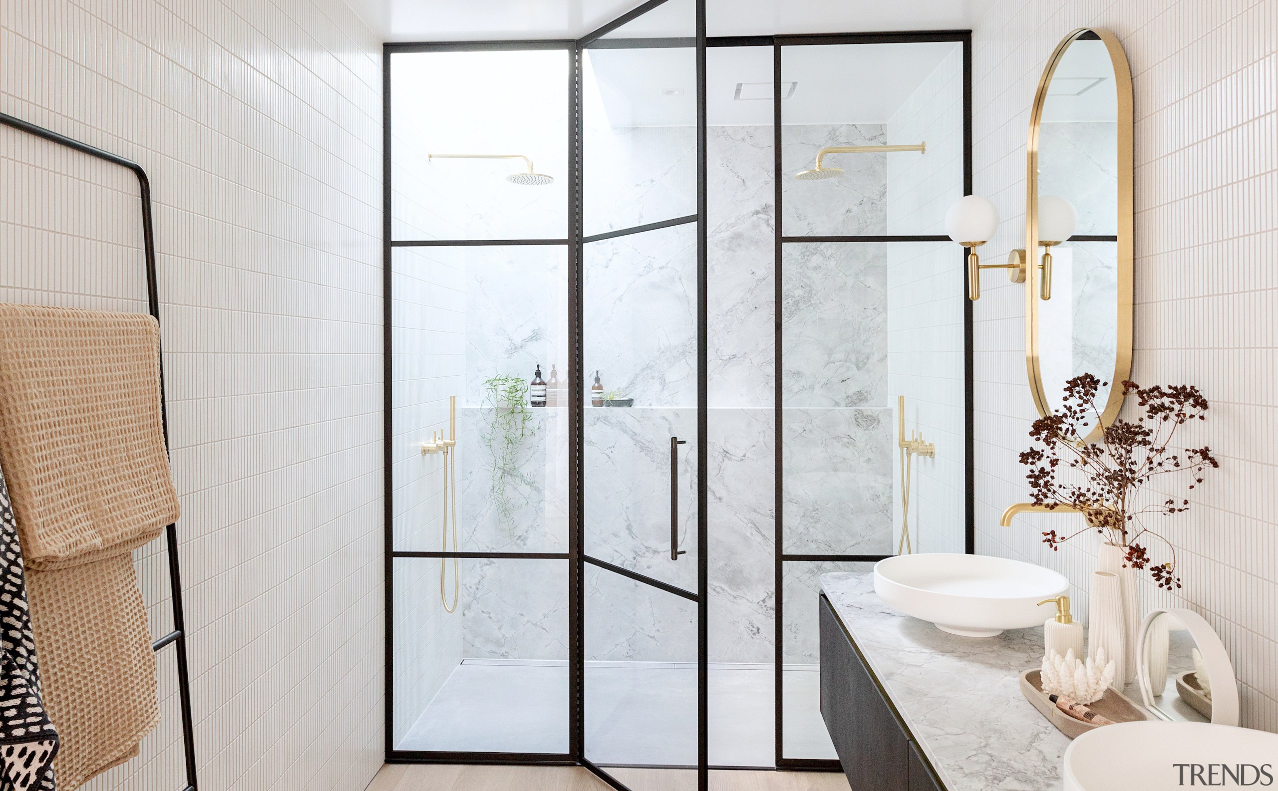 A leaning towel rack echoes the lines of 