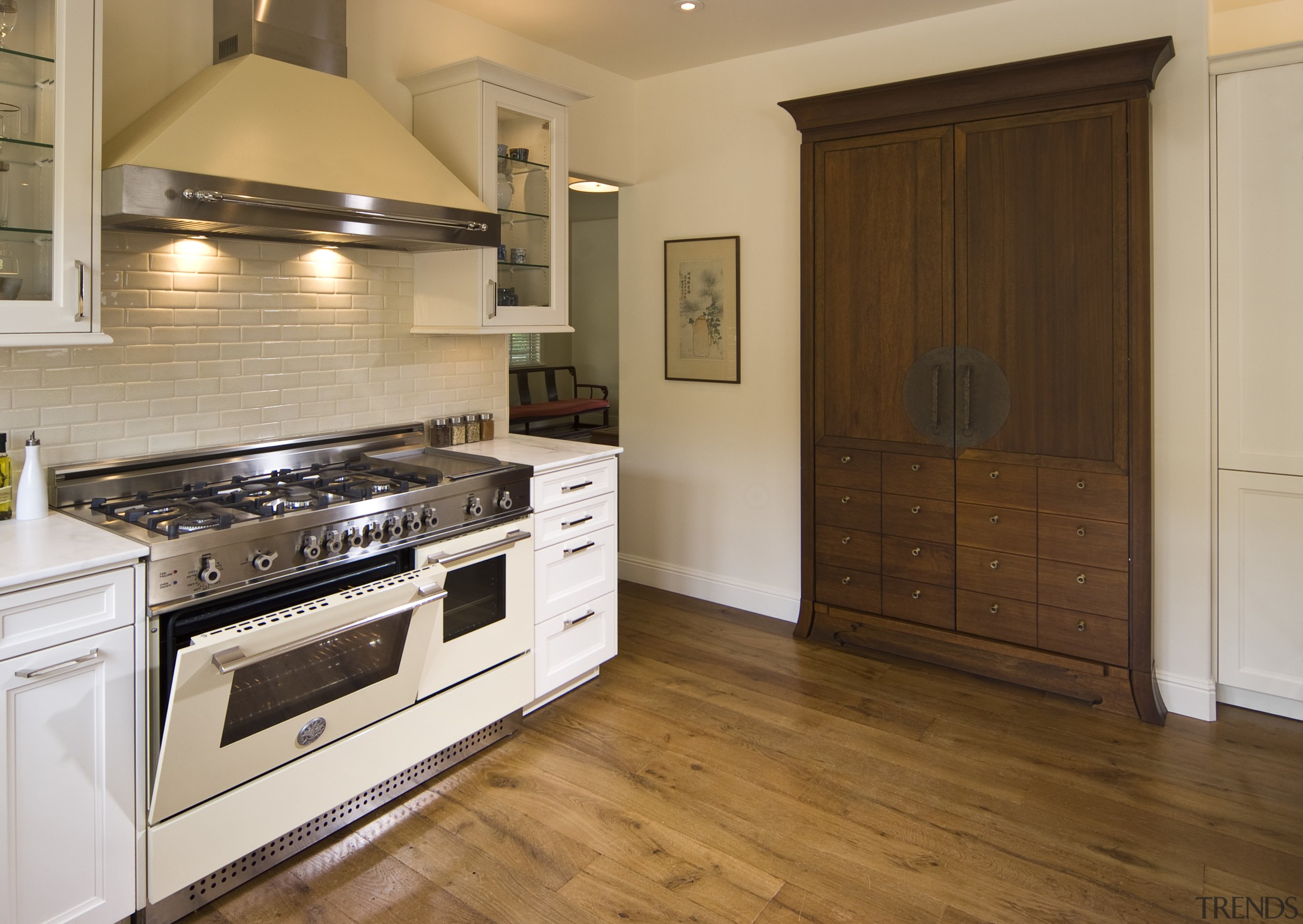 View of a traditional-styled kitchen which features stainless cabinetry, countertop, cuisine classique, floor, flooring, hardwood, home appliance, interior design, kitchen, laminate flooring, real estate, room, tile, wood, wood flooring, brown, orange