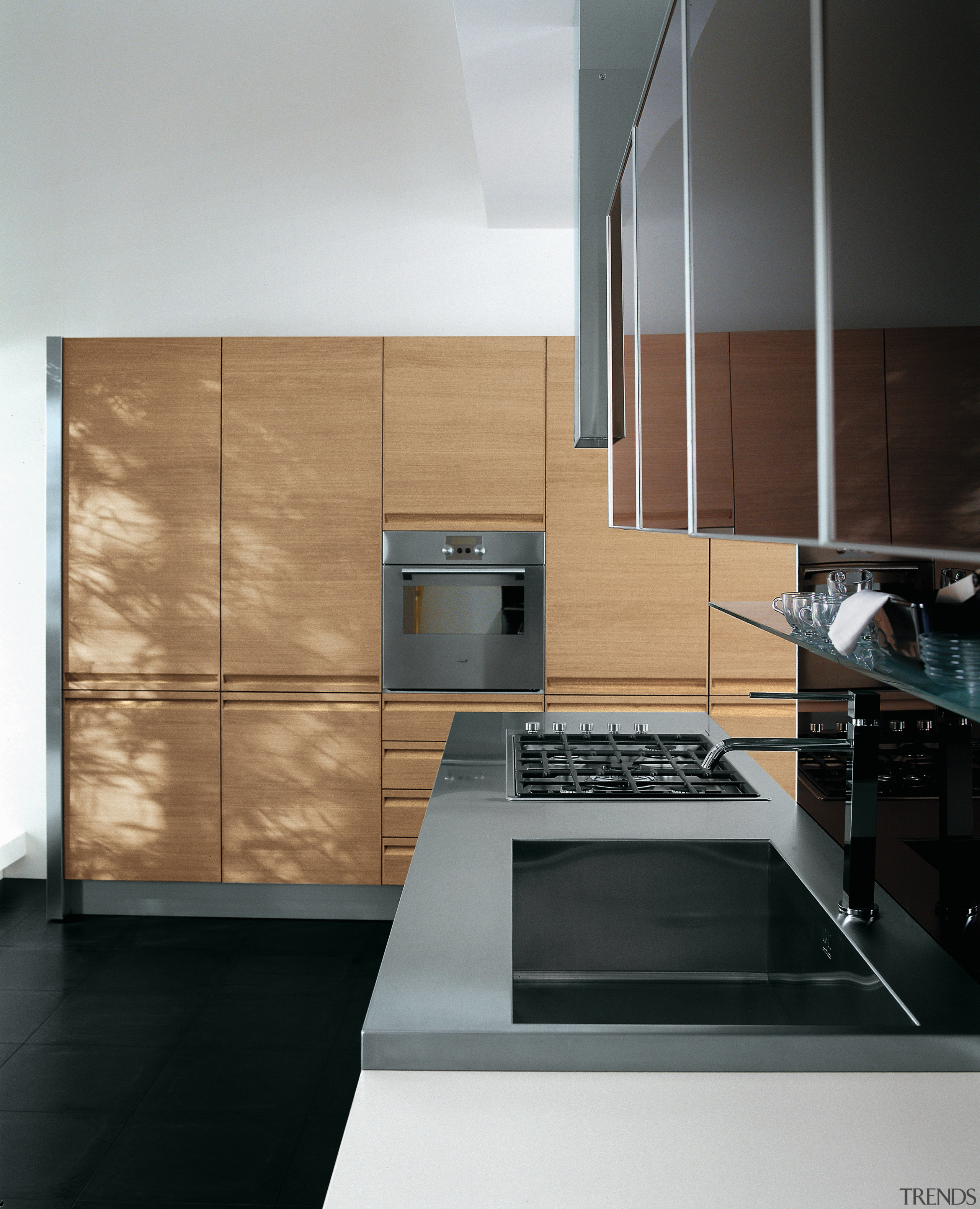 Kitchen with dark gray cabinetry along top cabinets, cabinetry, countertop, floor, home appliance, interior design, kitchen, product design, black