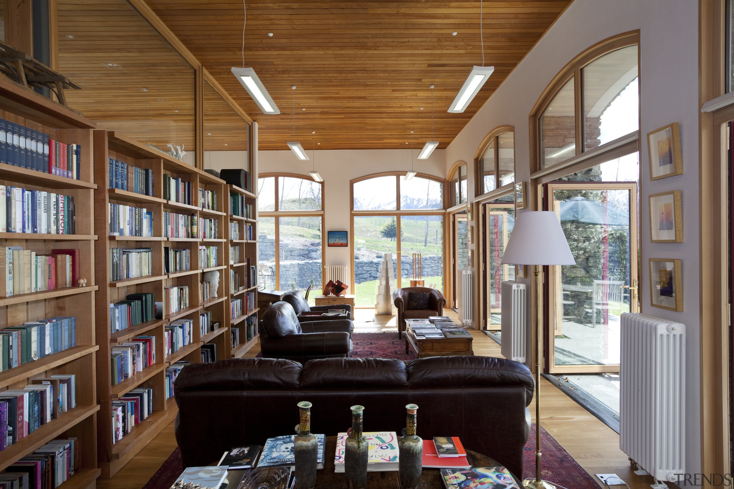 This home in Queenstown was renovated by architect ceiling, institution, interior design, library, living room, public library, real estate, window, brown