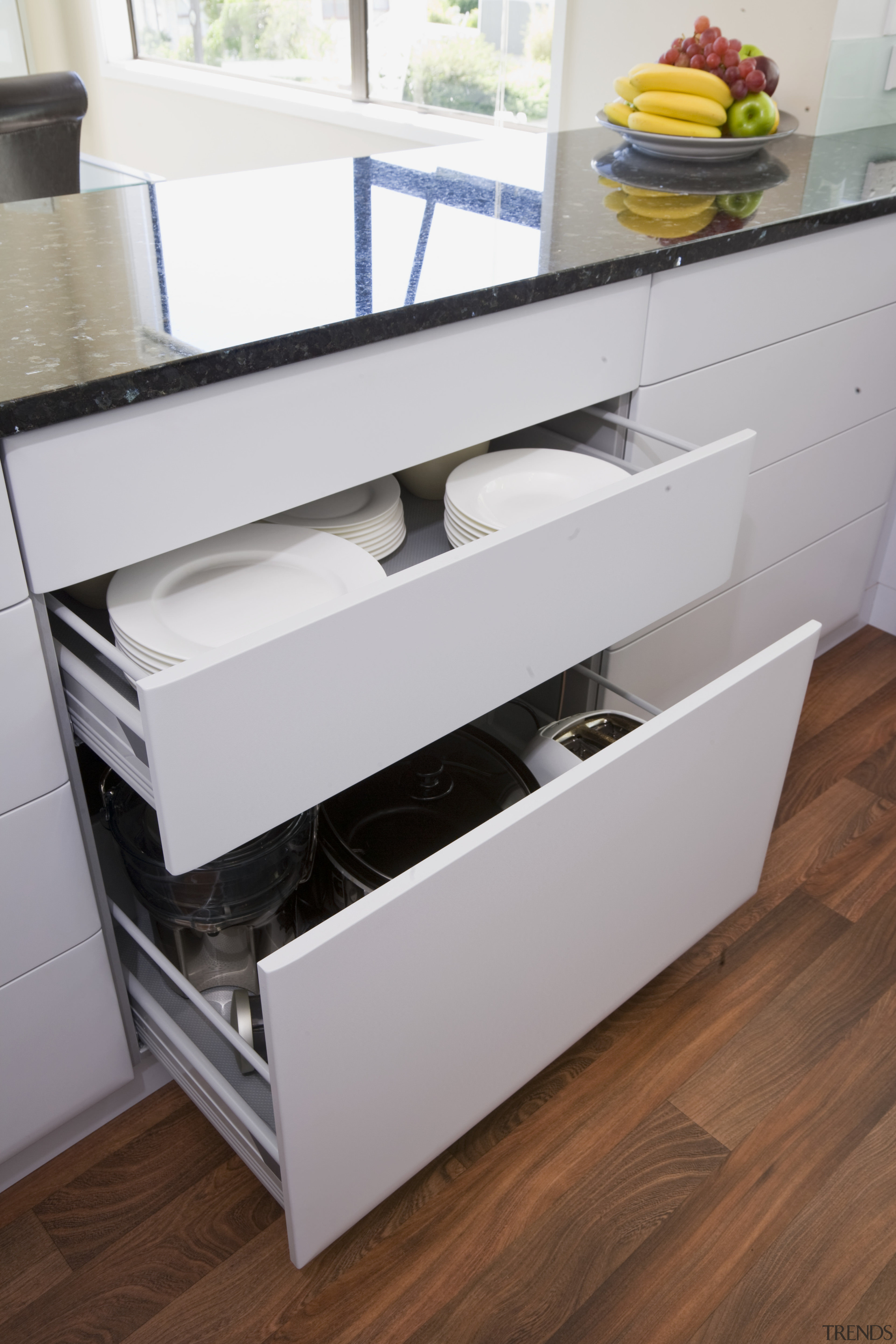 View of a kitchen designed by Denele Design chest of drawers, drawer, floor, furniture, kitchen, product, product design, shelf, sideboard, table, gray