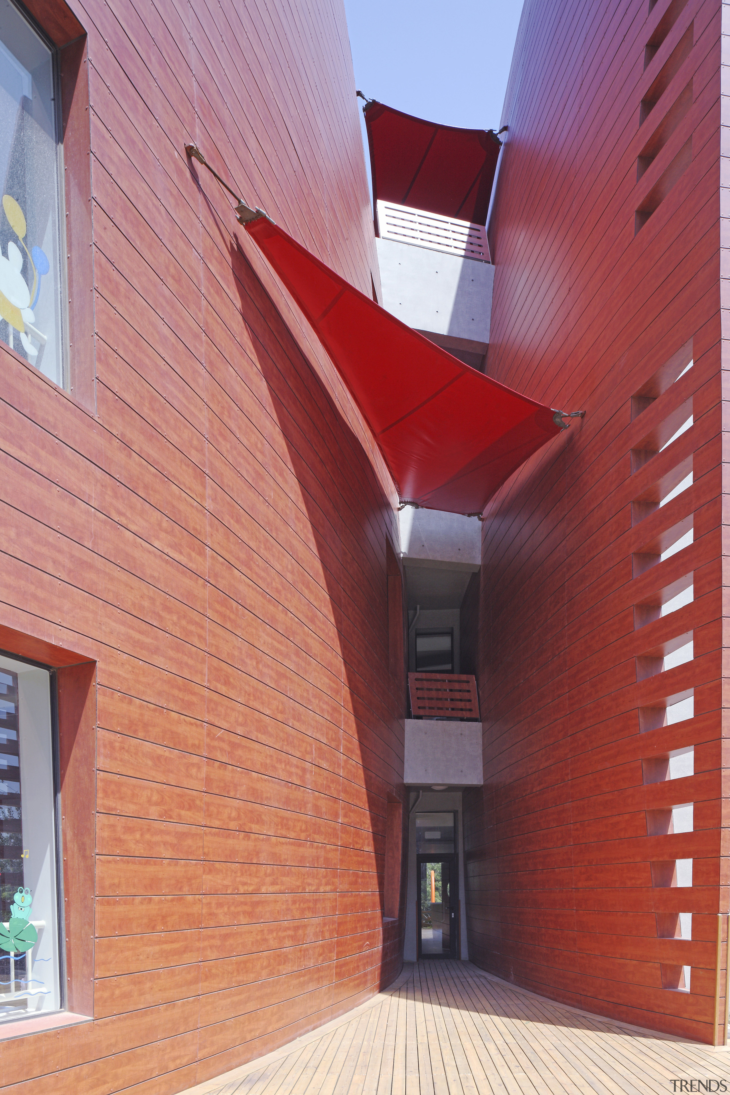 View of Dalian Preschool, with curvilinear forms and architecture, brick, building, ceiling, daylighting, facade, house, real estate, wall, red