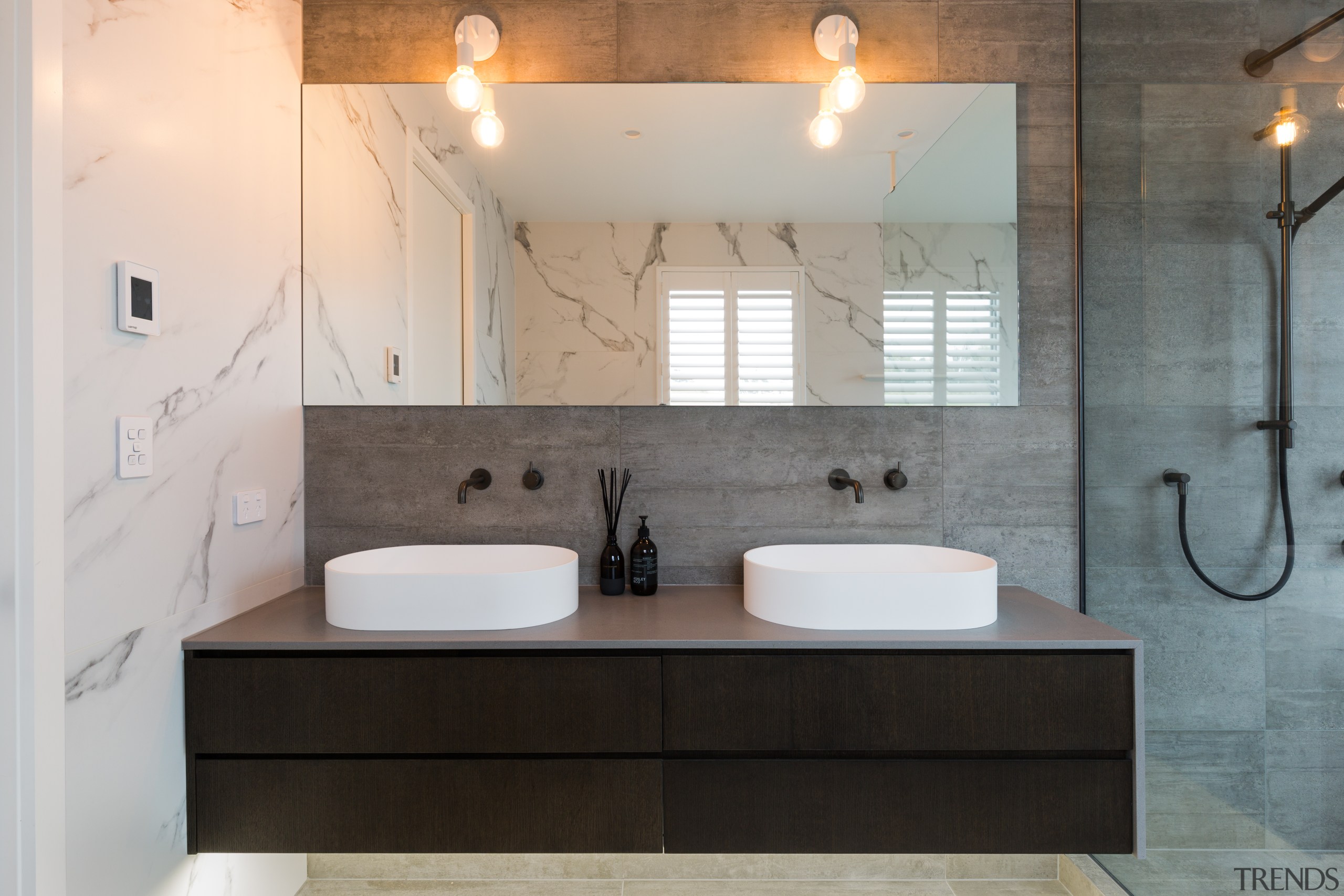 The owners wanted a luxury feel with an bathroom, bathroom accessory, ceramic, countertop, floor, home, interior design, plumbing fixture, room, sink, tap, tile, gray