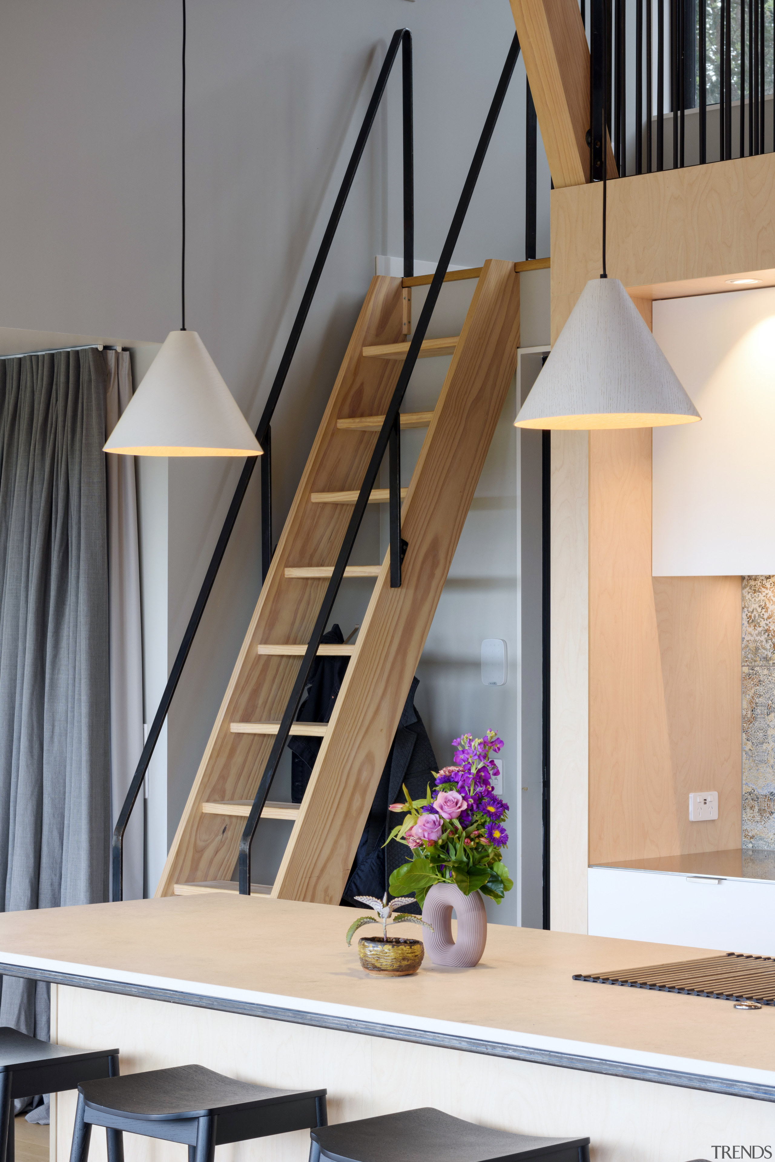 A stylish wood stair ladder leads to the 