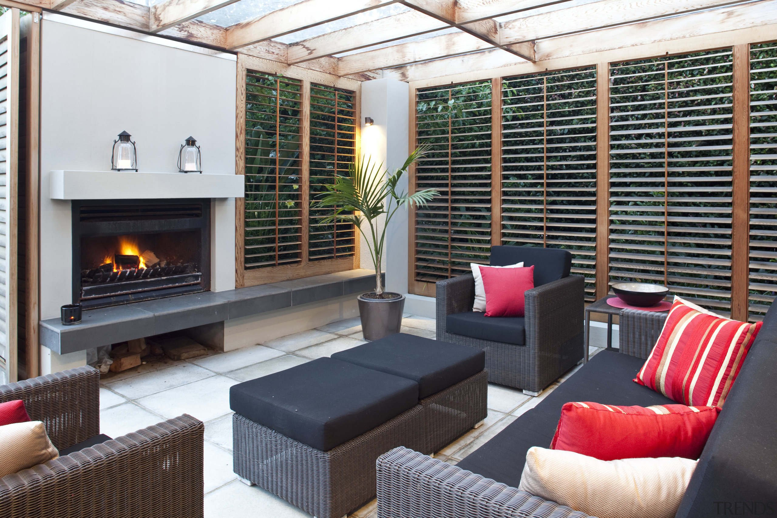 View of outdoor entertainment area, with pool, paving, hearth, interior design, living room, real estate, white, black