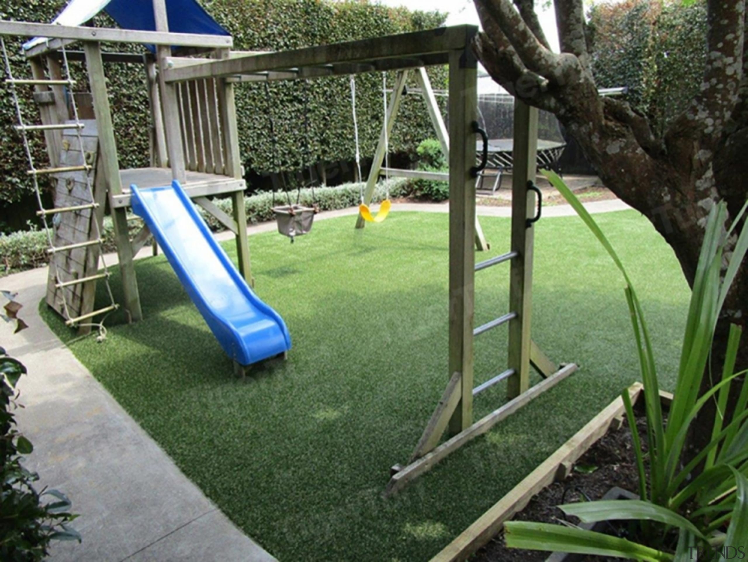 A backyard playground in Auckland that uses artificial turf, backyard, chute, grass, lawn, leisure, outdoor play equipment, plant, playground, public space, recreation, yard, green