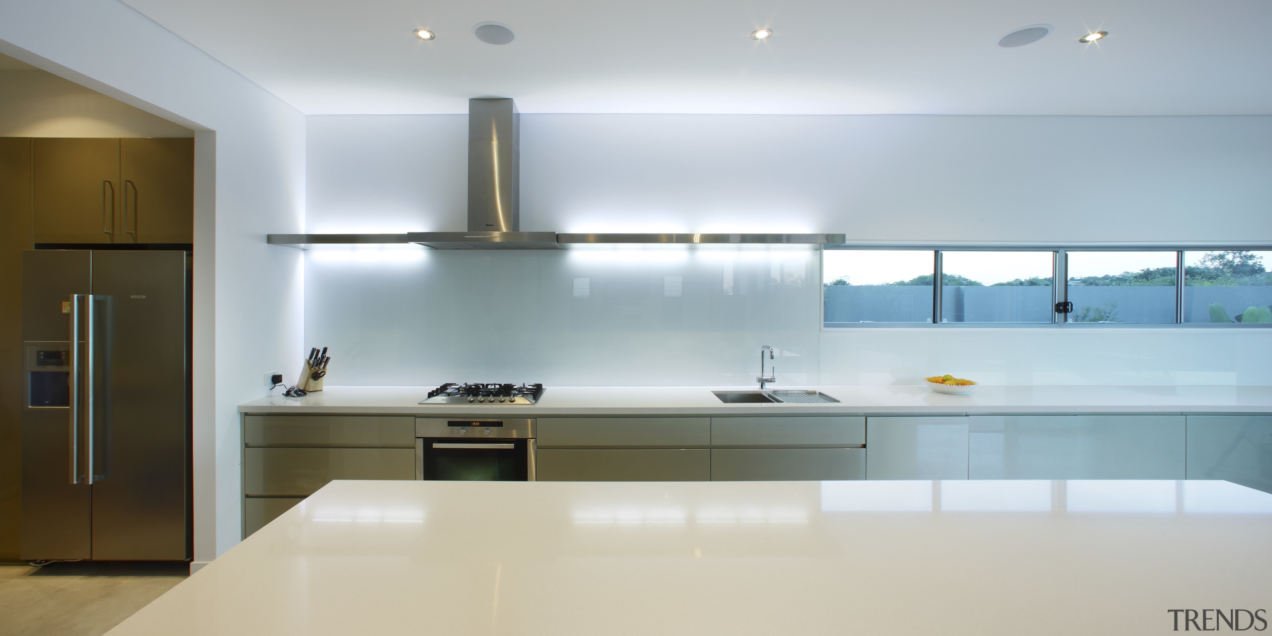 view of the kitchen in this house built architecture, ceiling, countertop, floor, interior design, kitchen, product design, room, sink, under cabinet lighting, gray